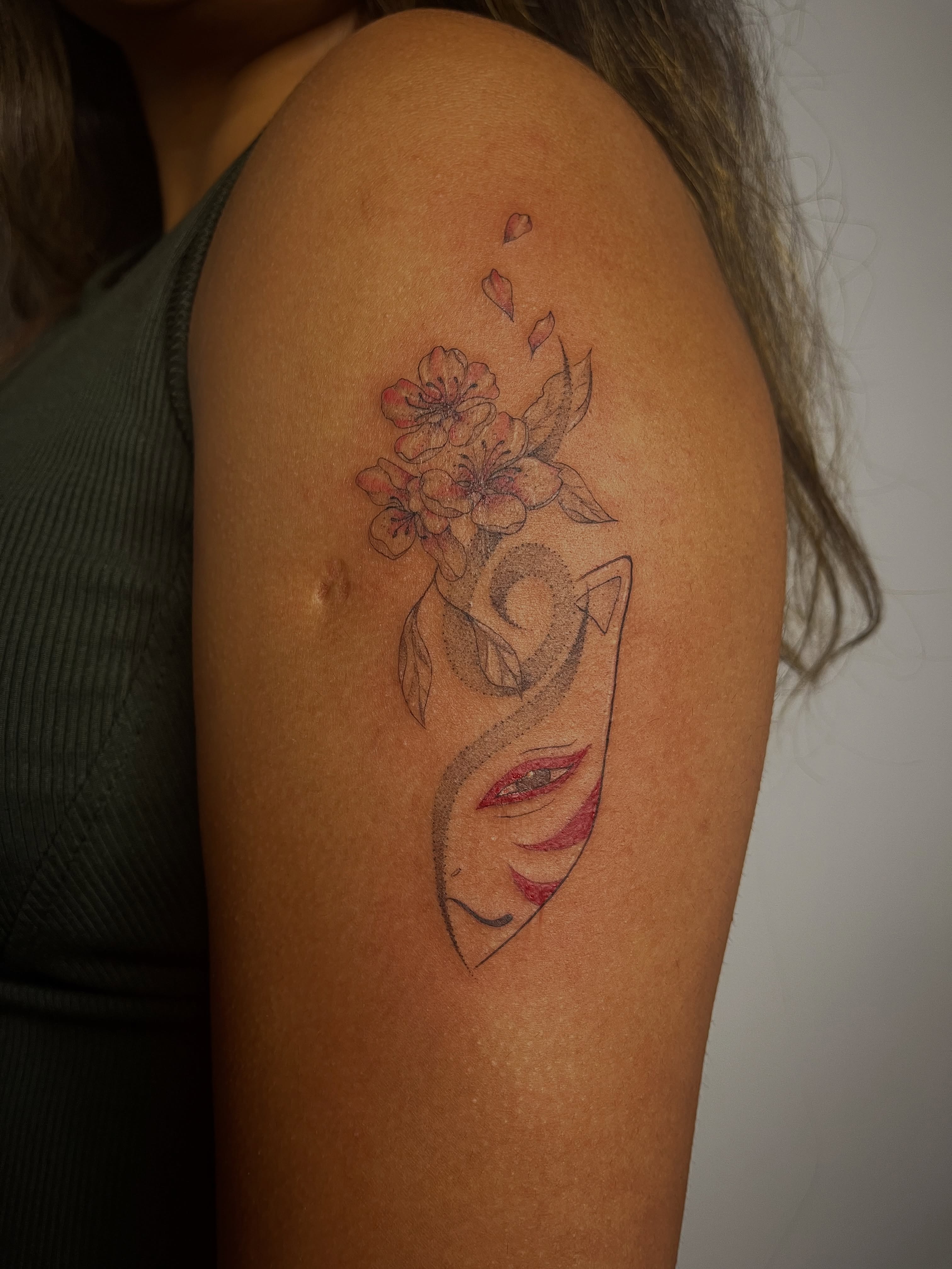 Abstract face with flowers dotwork tattoo on the shoulder by Sid