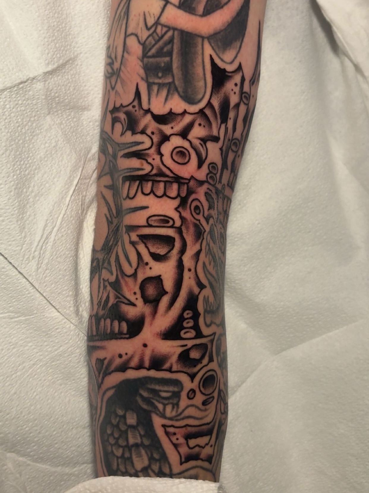 Mask American traditional tattoo on the forearm by Chris Prince Jr., Miamisburg, Ohio