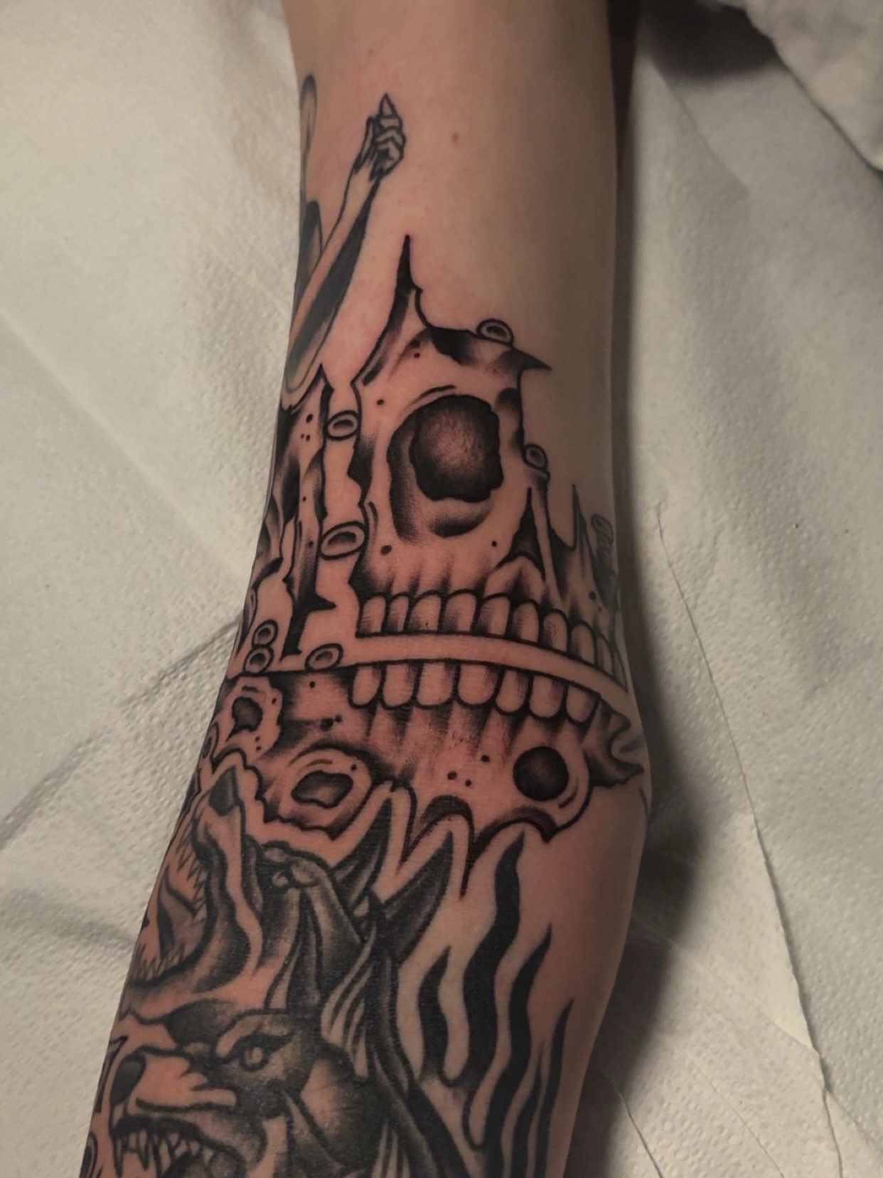 Skull and flames geometric tattoo on the forearm by Chris Prince Jr., Miamisburg, Ohio