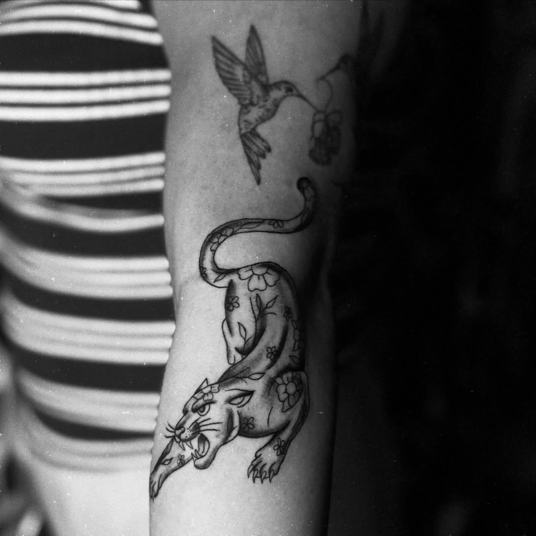 Panther and hummingbird black and grey tattoo on the forearm by Giana Martinez, Wichita, Kansas