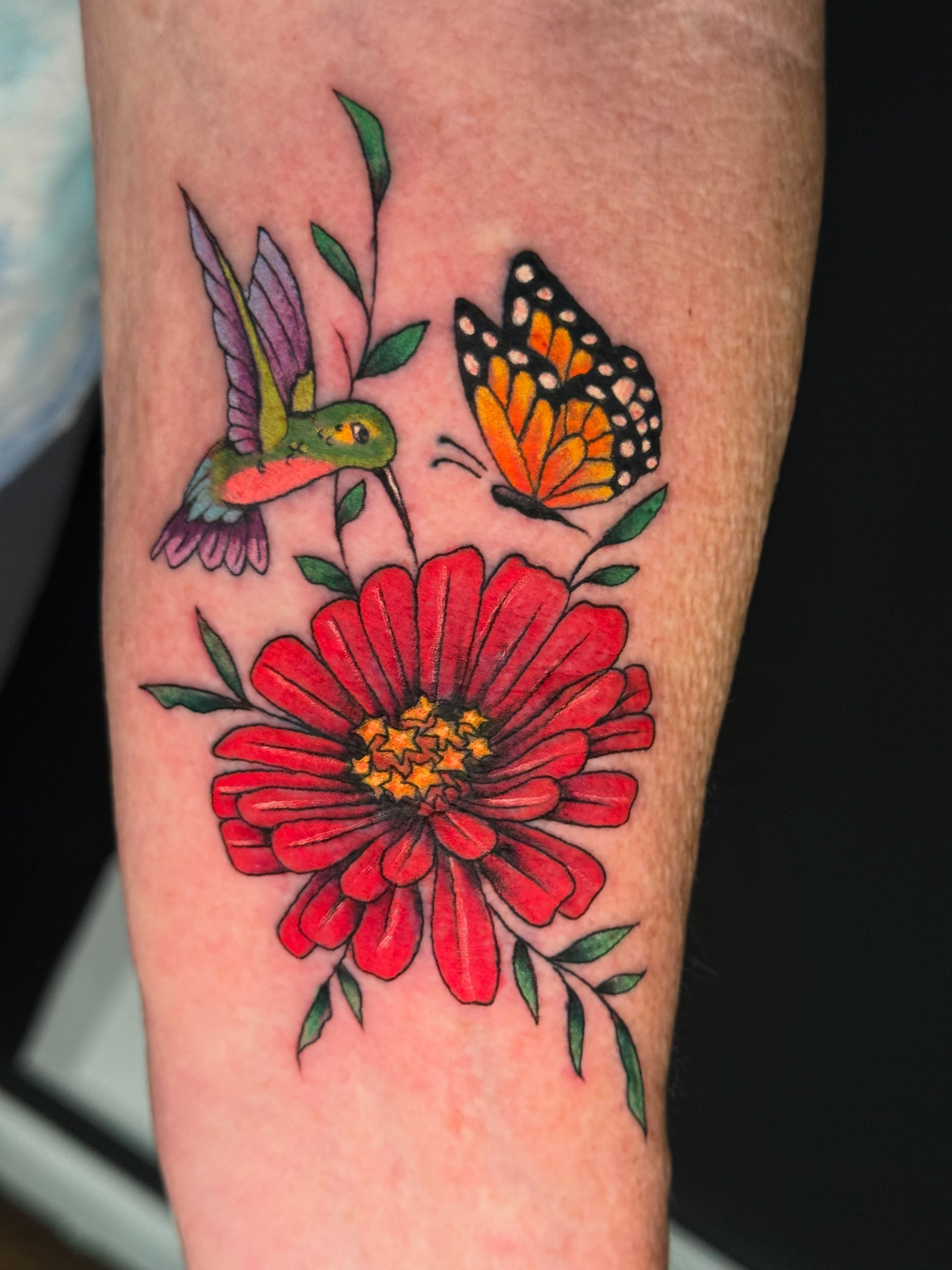 Flower, hummingbird, butterfly American traditional tattoo on the forearm by Michelle Balhan