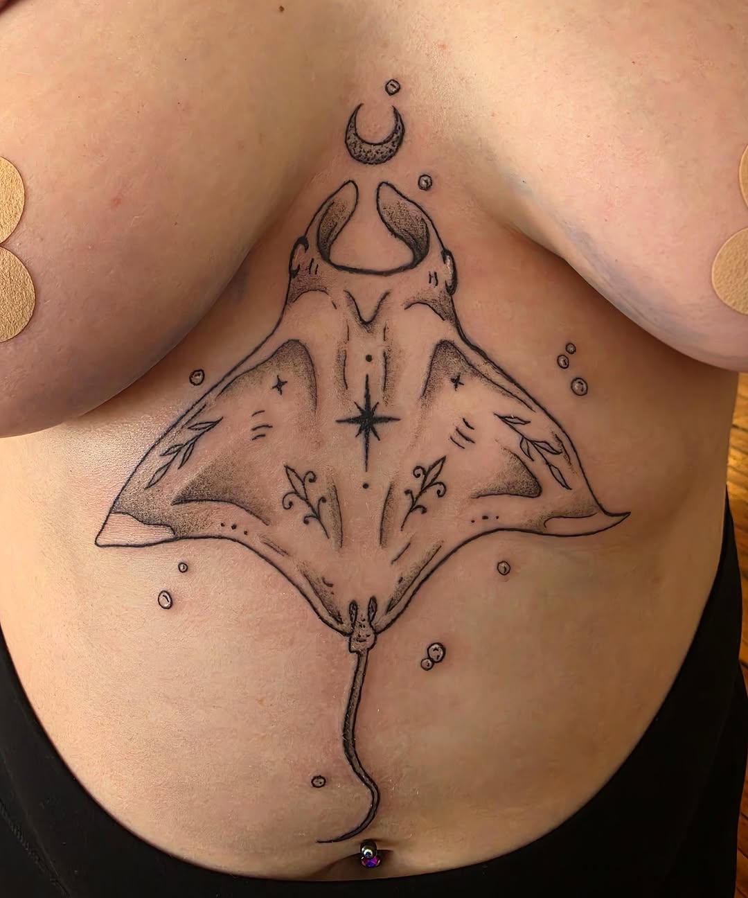 Manta ray with moon and stars fine line tattoo on the chest by Solstice Tattoos by Savannah Sadler (future, Salisbury, North Carolina