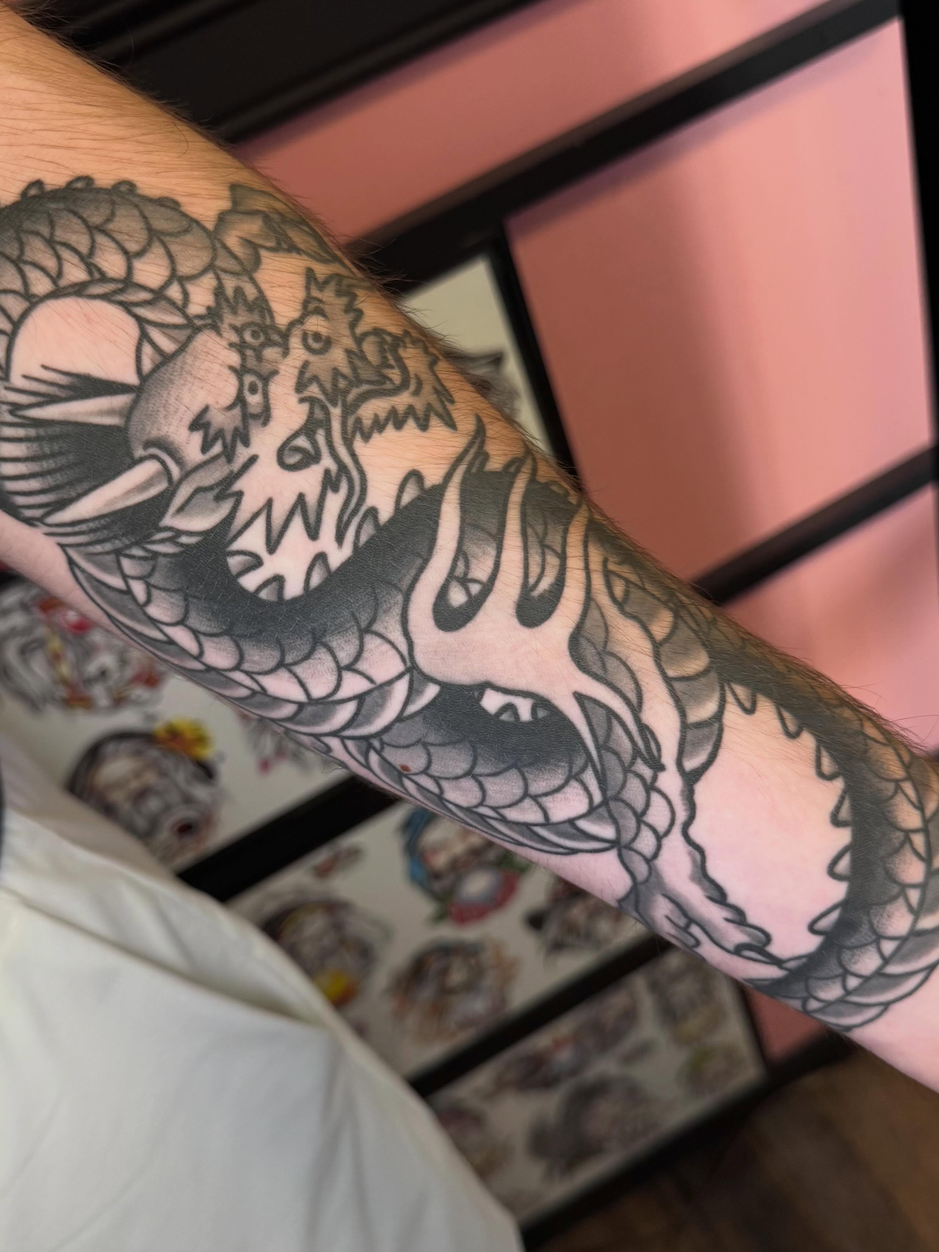 Dragon American traditional tattoo on the forearm by Landon Lewis