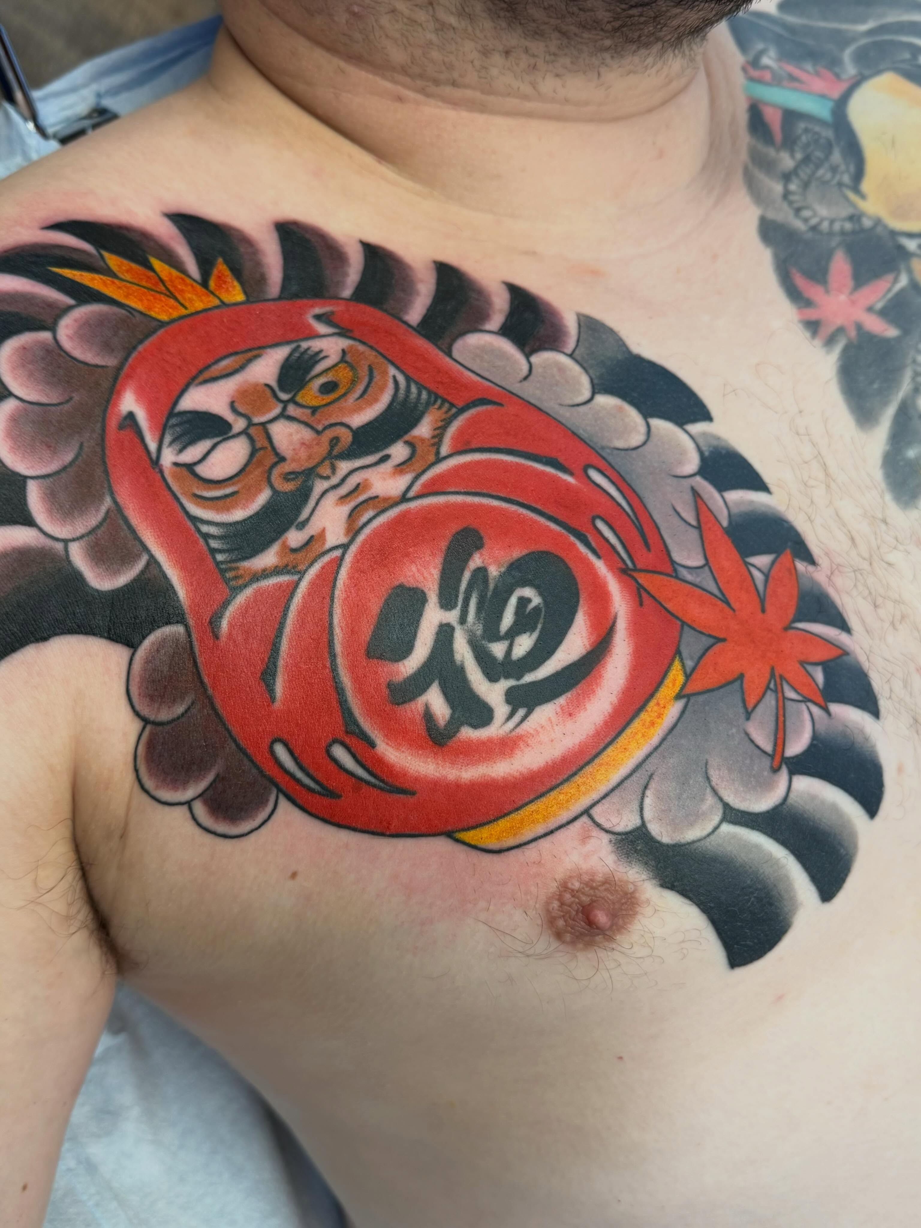 Daruma doll japanese irezumi tattoo on the chest by Landon Lewis