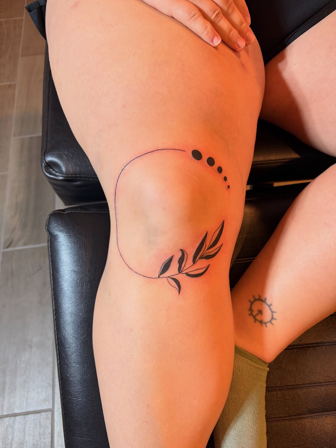 Circular line with dots and leaves ornamental tattoo on the thigh by Inky Birdz Tattoos