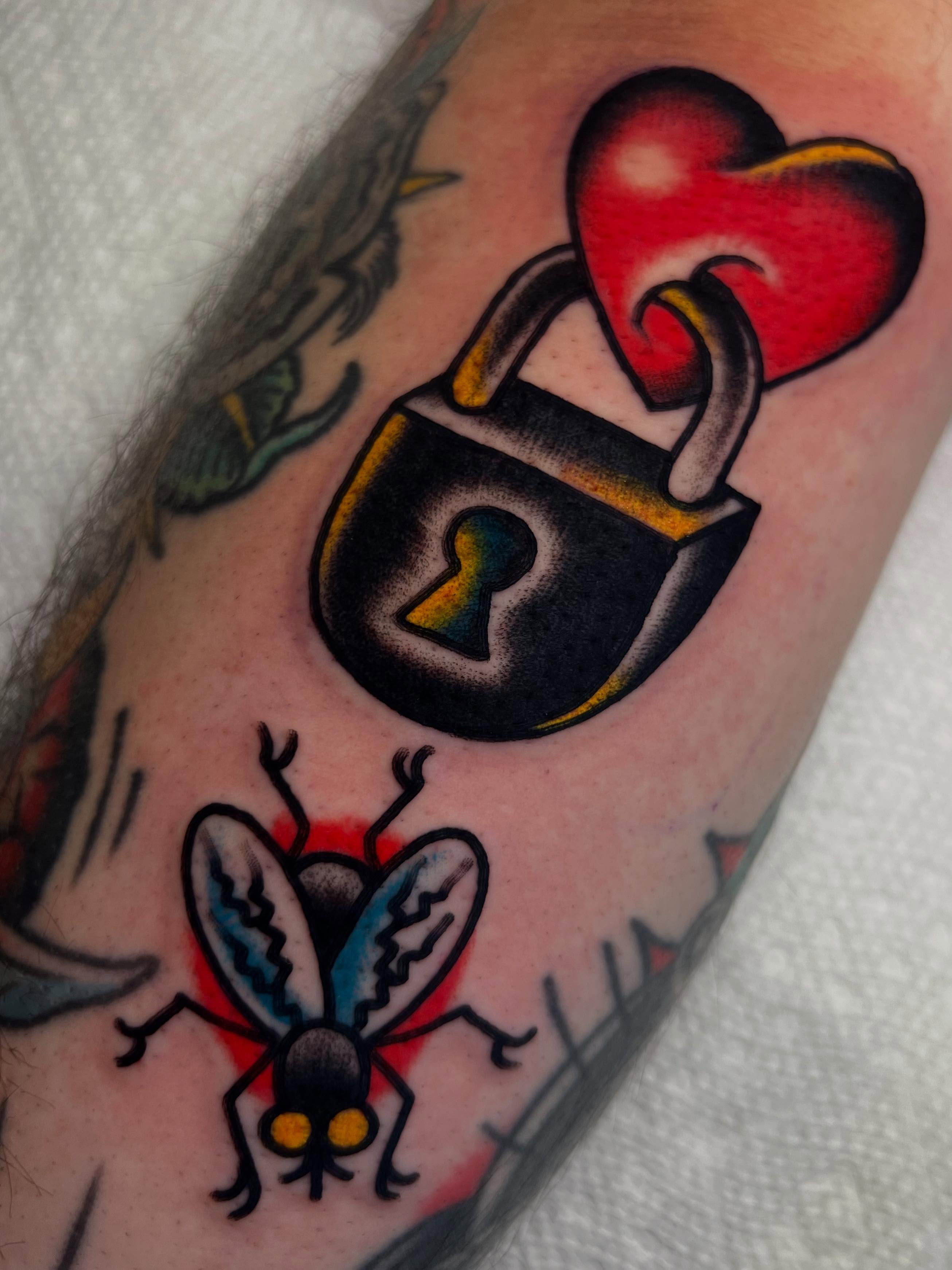 Lock and heart American traditional tattoo on the forearm by ᴍᴀᴛᴛ ᴀʟᴇxᴀɴᴅᴇʀ