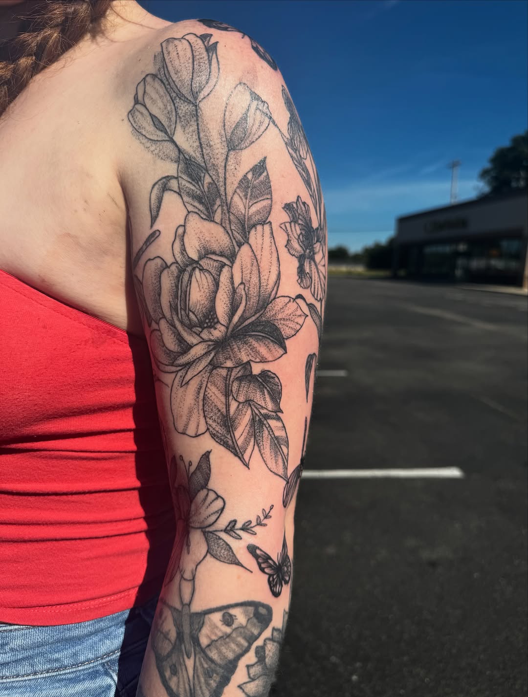 Floral arrangement with butterflies fine line tattoo on the upper arm by Lexy