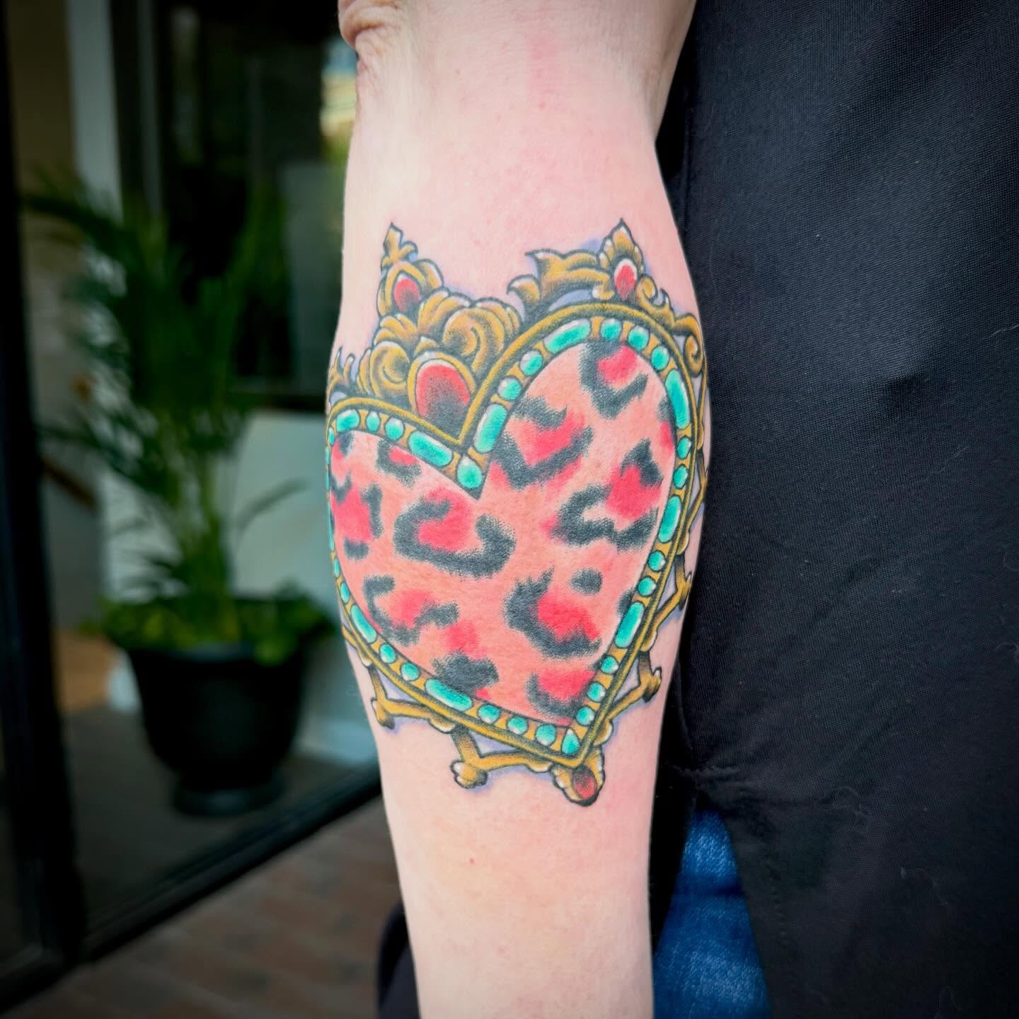 Heart with leopard print new school tattoo on the forearm by Mike Lachowicz