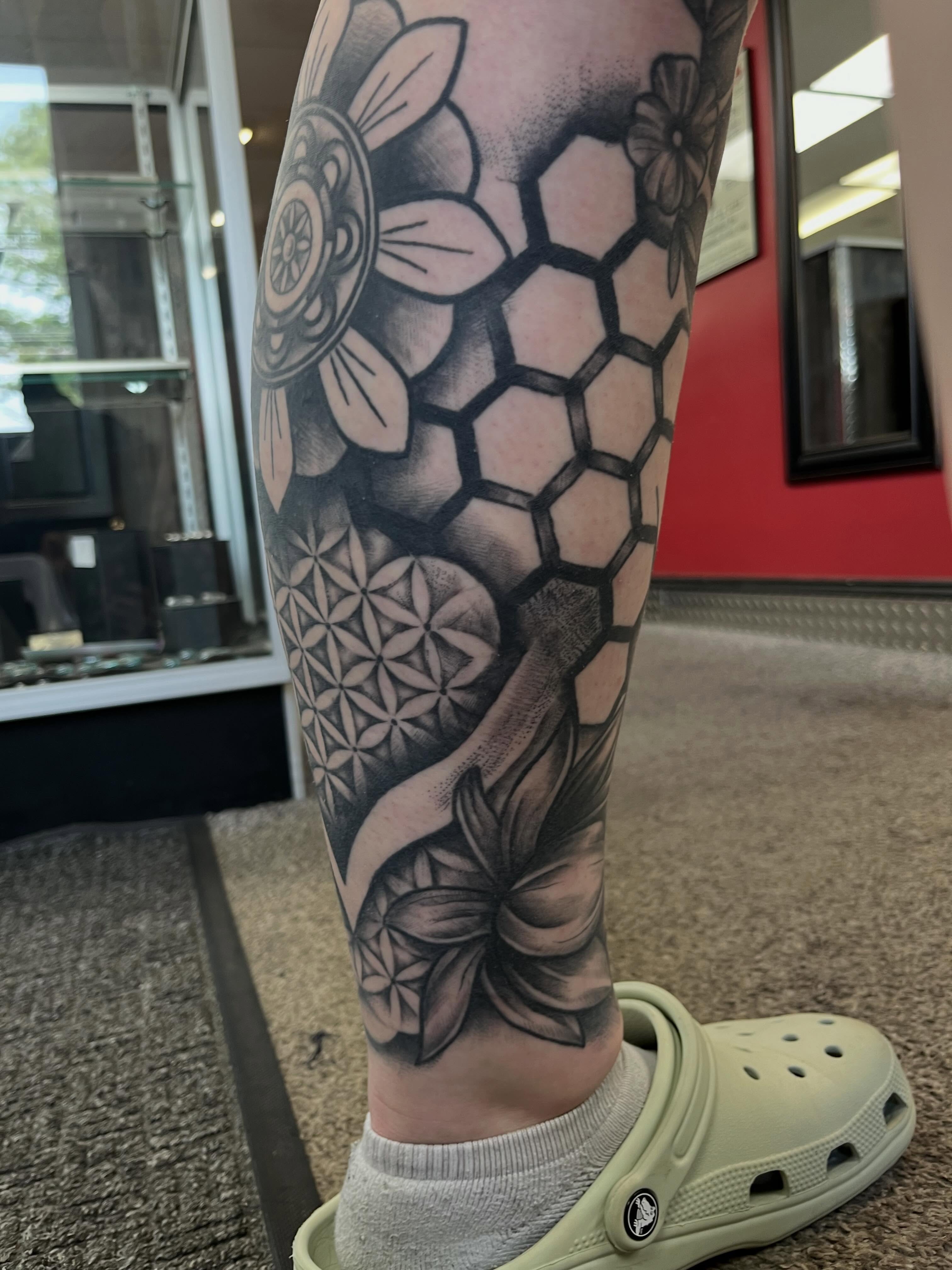 Geometric floral pattern geometric tattoo on the calf by Danielle Lorandeau