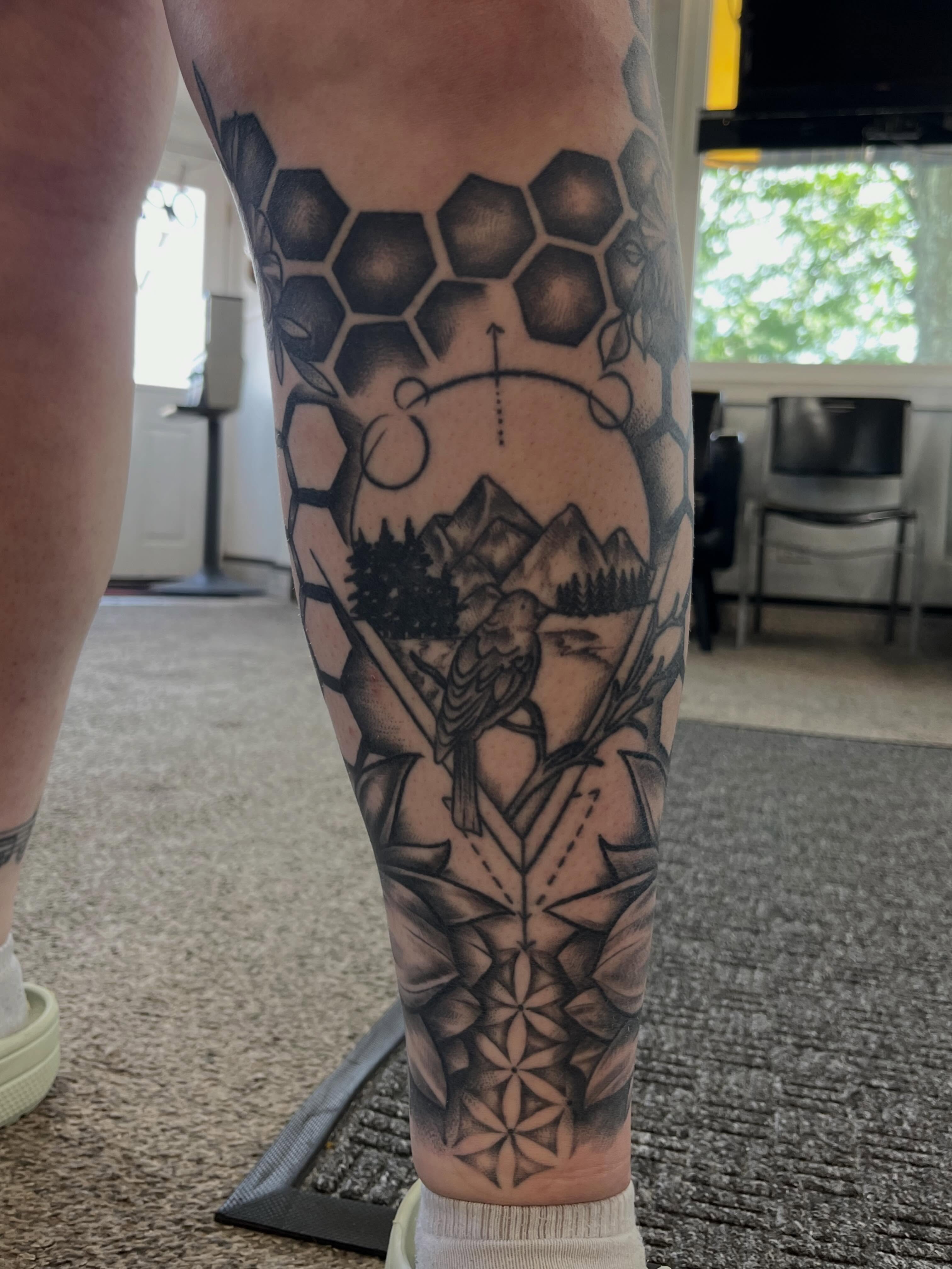 Mountain landscape geometric tattoo on the calf by Danielle Lorandeau