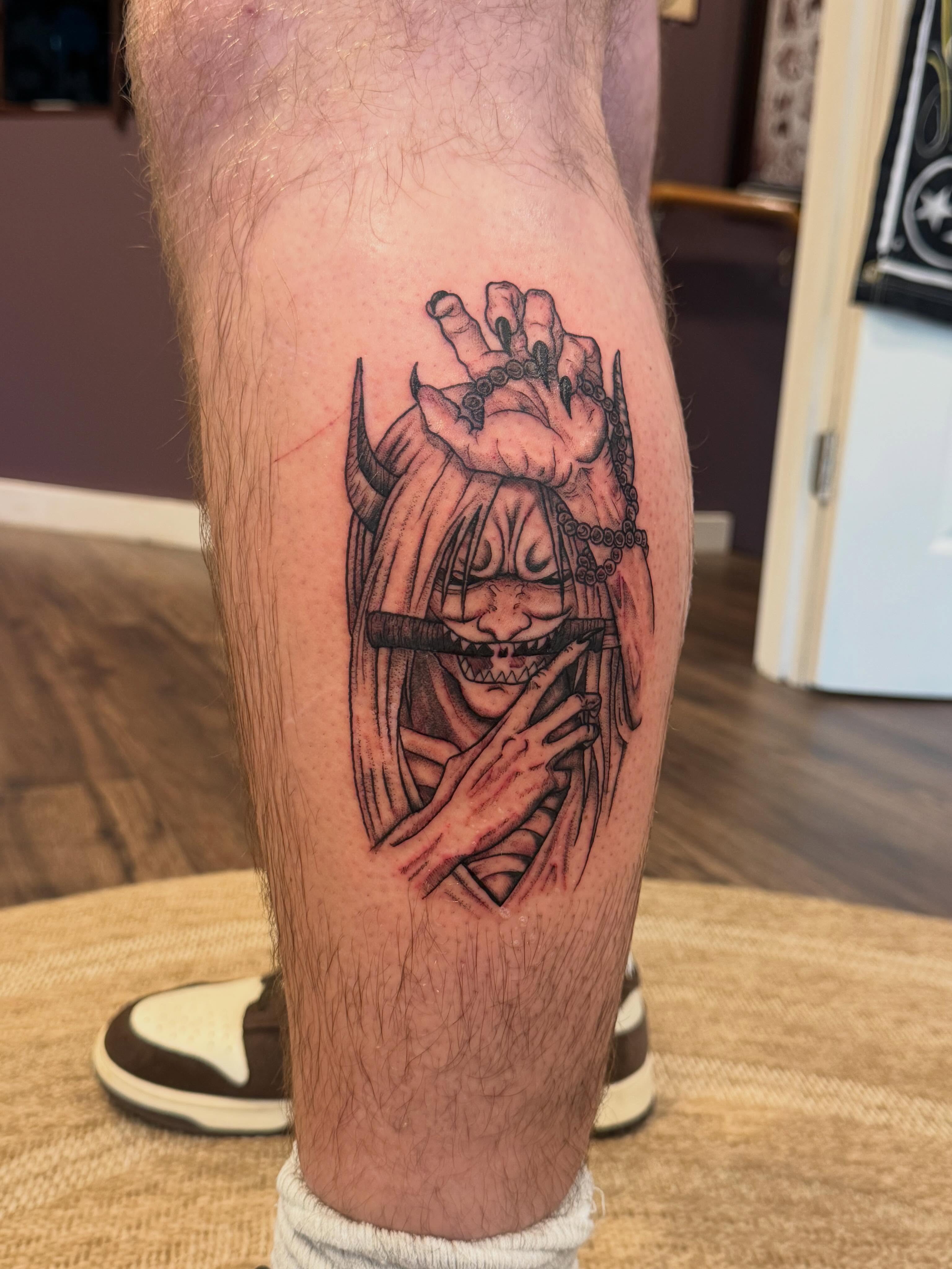 Demon mask dark realism tattoo on the calf by Aly Rucker, Murfreesboro, Tennessee