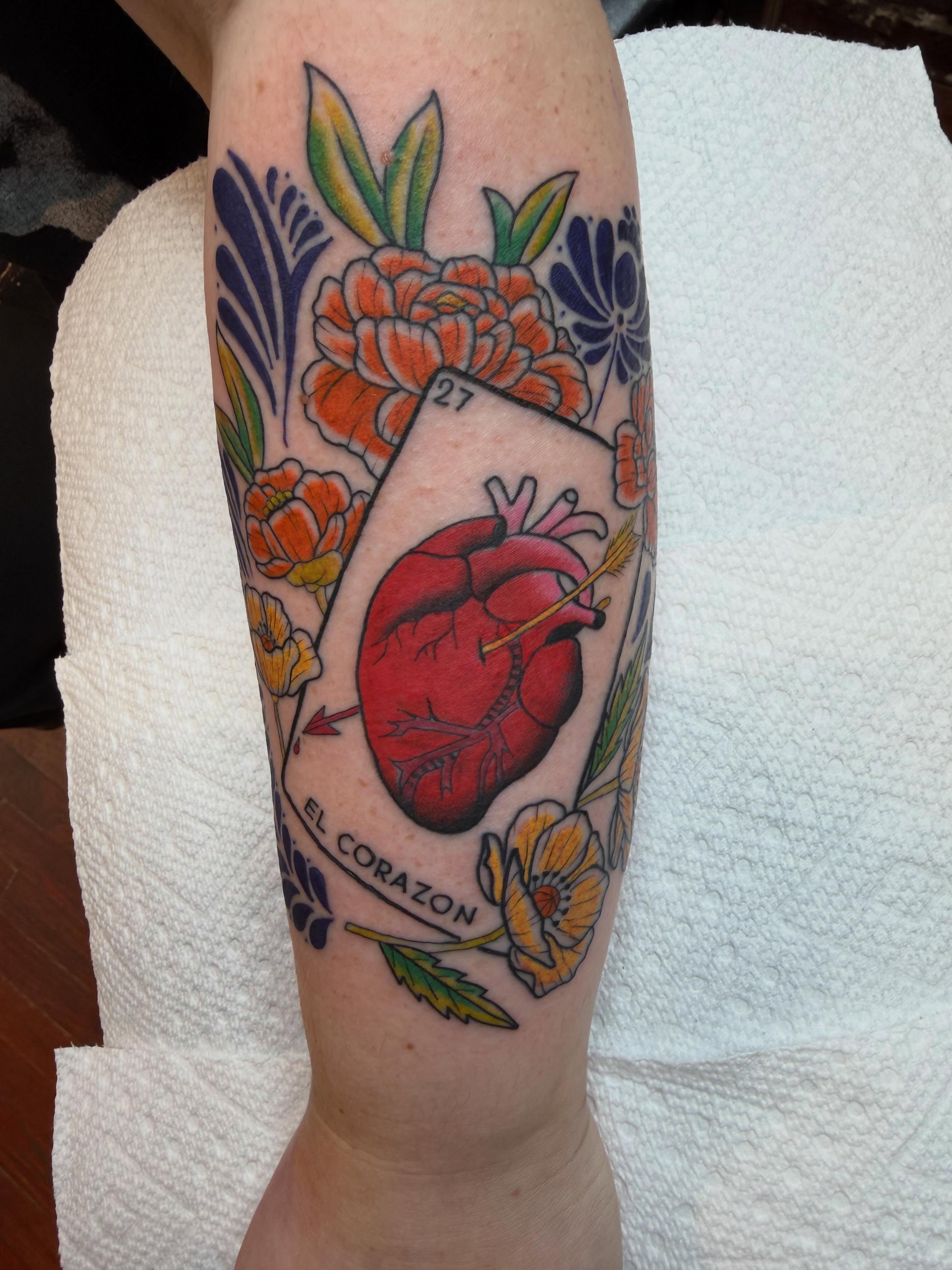 Heart with floral elements American traditional tattoo on the forearm by Evan Voelker