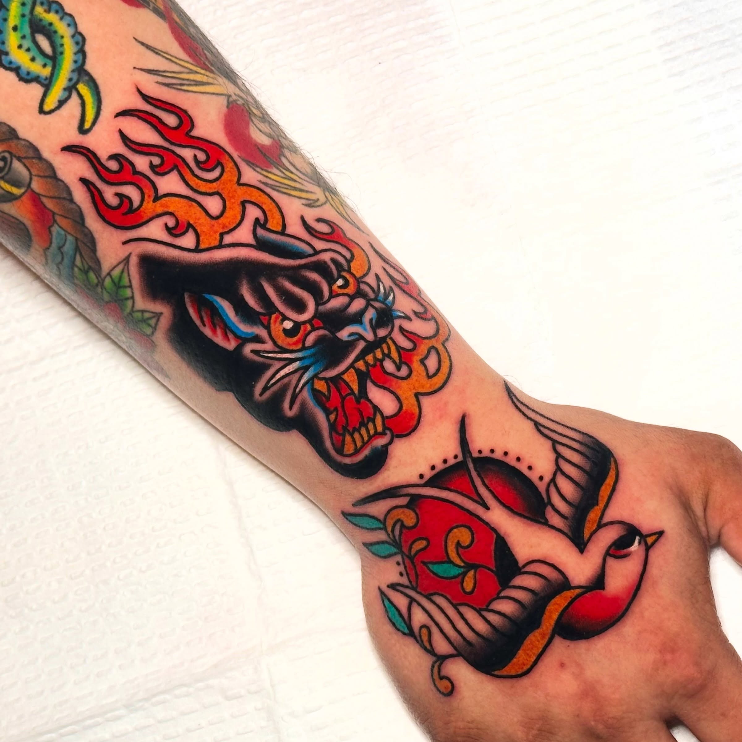 Dragon and bird American traditional tattoo on the forearm by Kiki Painmaker Trad Tattooer 🧨
