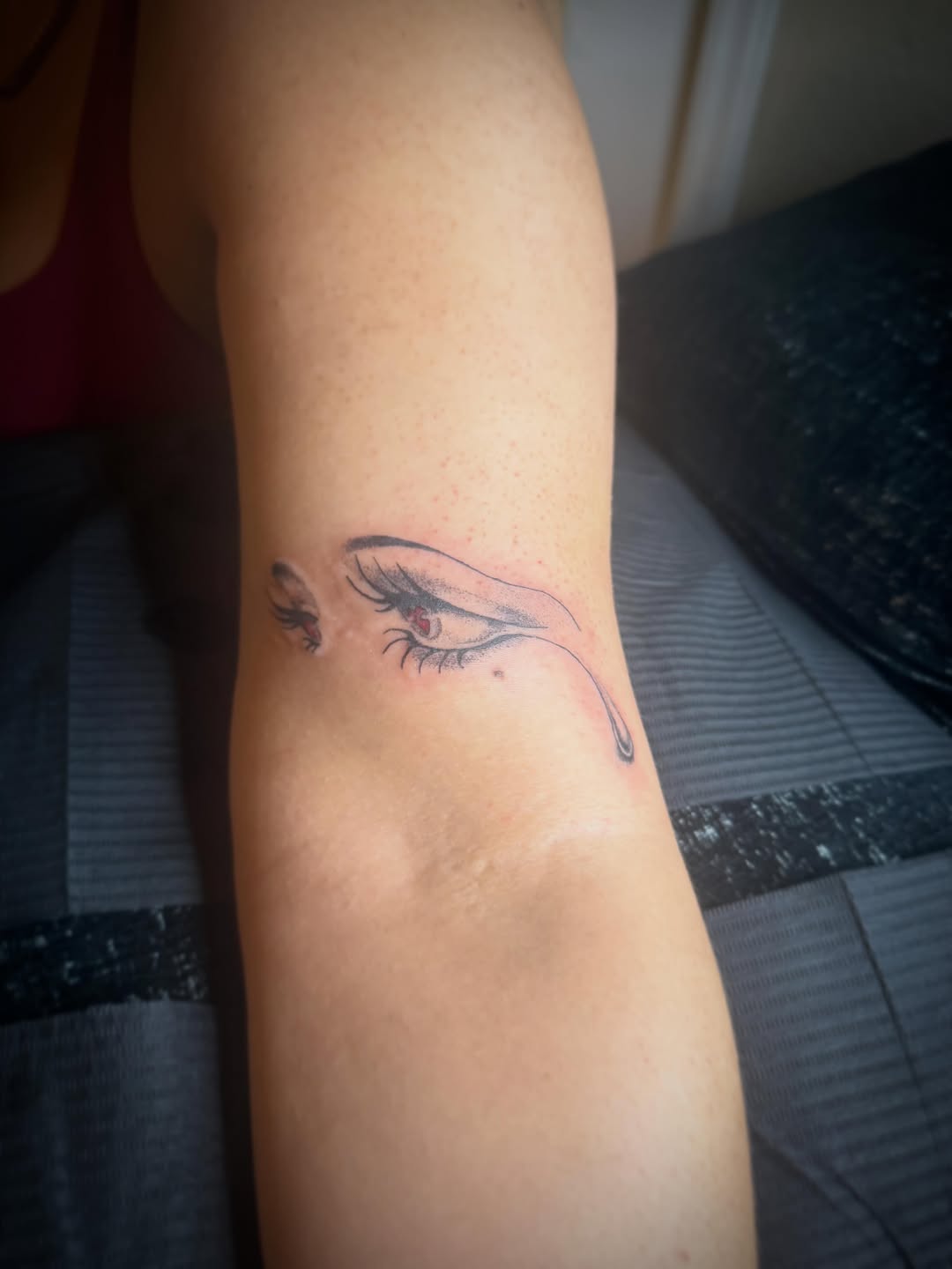 Crying eye surrealism tattoo on the forearm by Danny Garcia