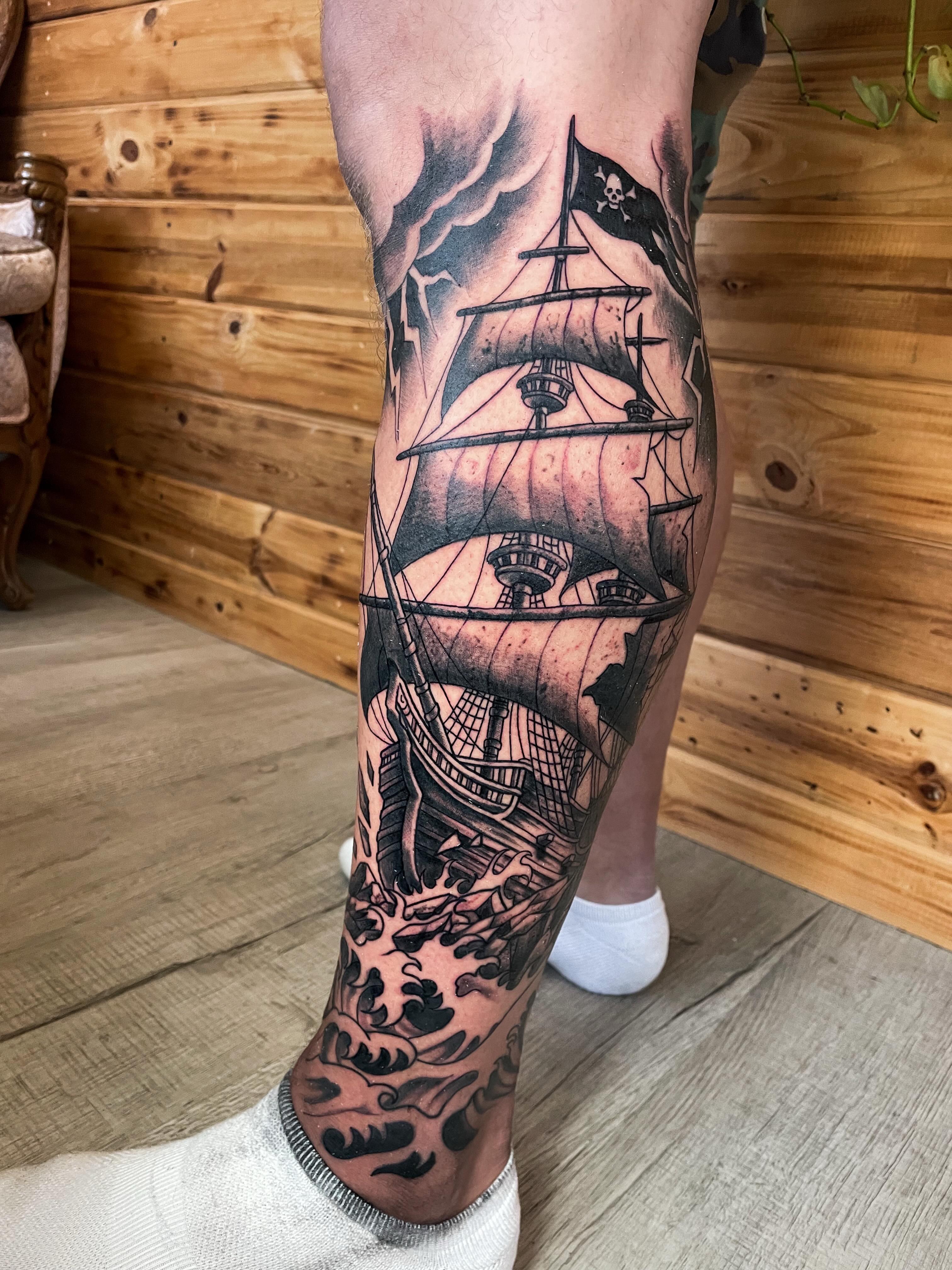 Pirate ship black and grey tattoo on the calf by Dev Z