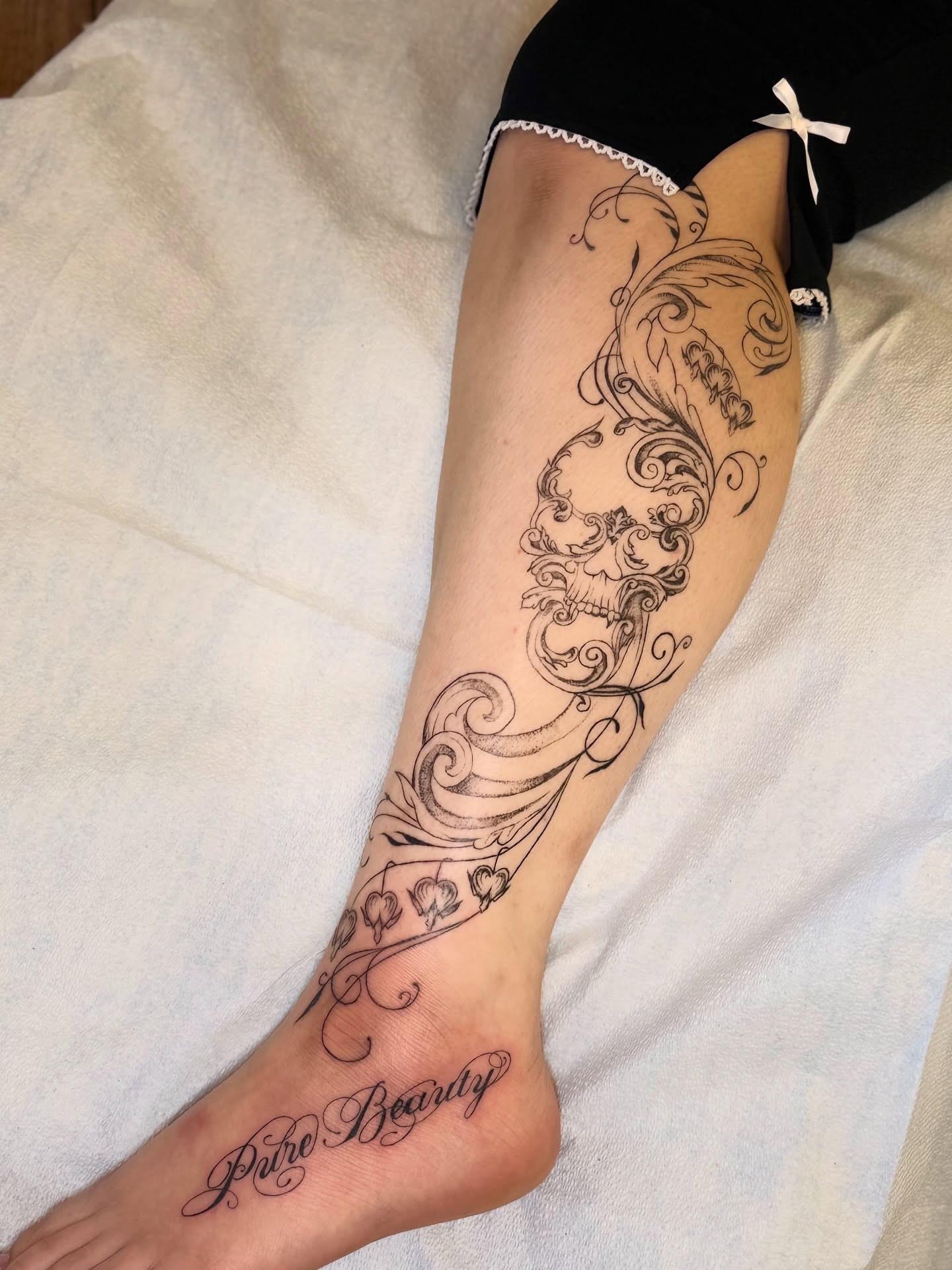 Swirls and hearts ornamental tattoo on the calf by Maddie Blosser, Portland, Oregon