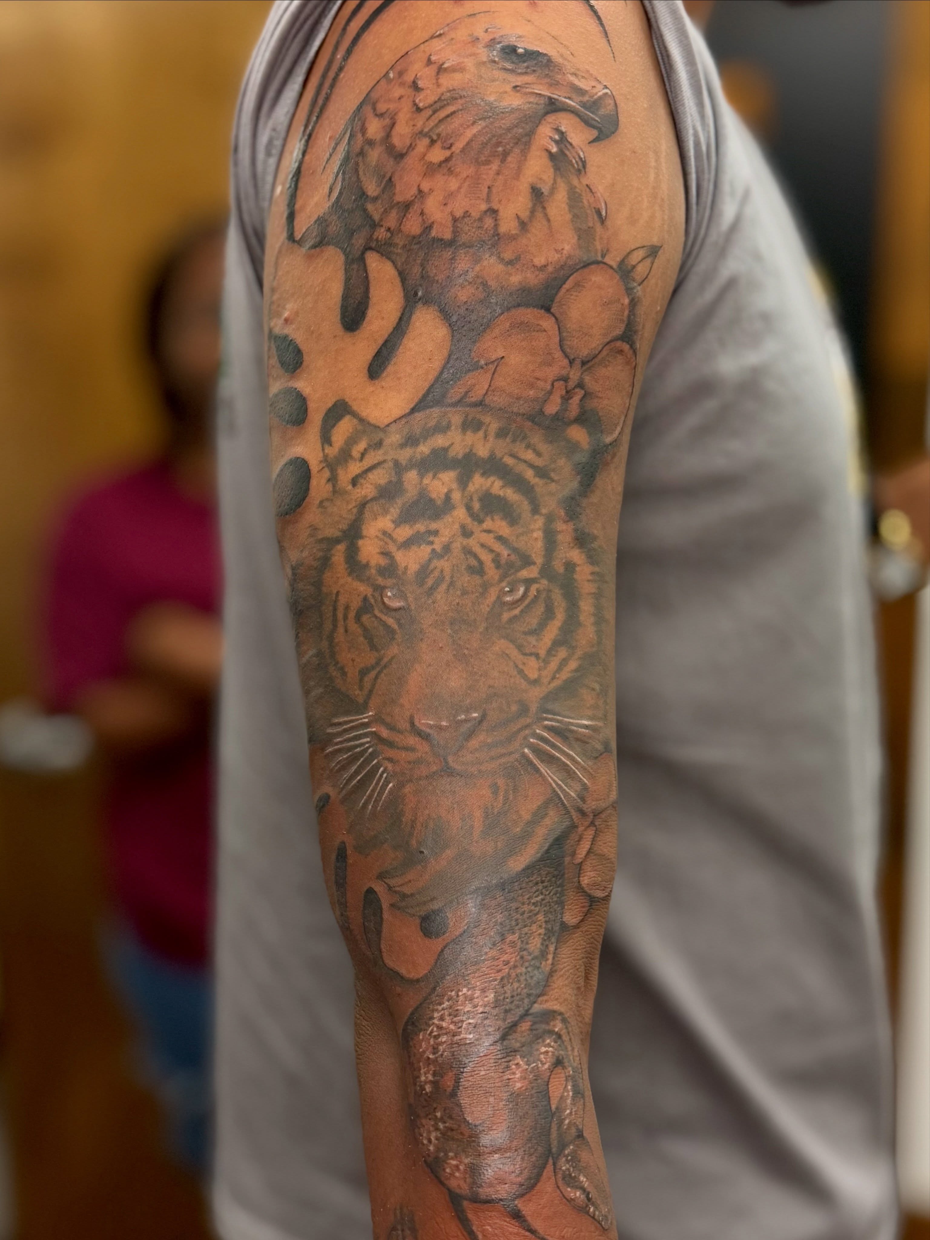 Tiger and eagle realism tattoo on the forearm by Halle Cooper