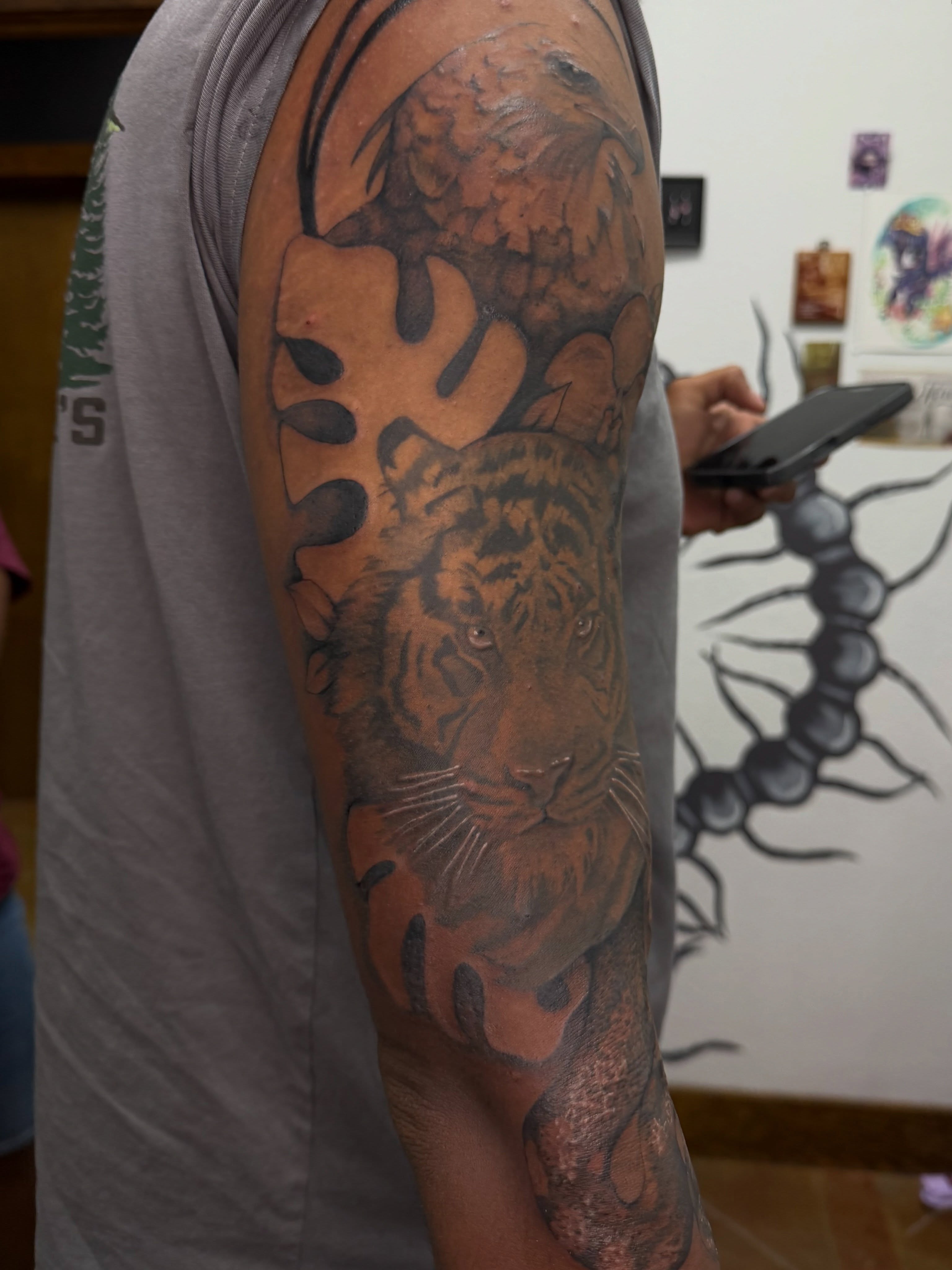Tiger realism tattoo on the forearm by Halle Cooper