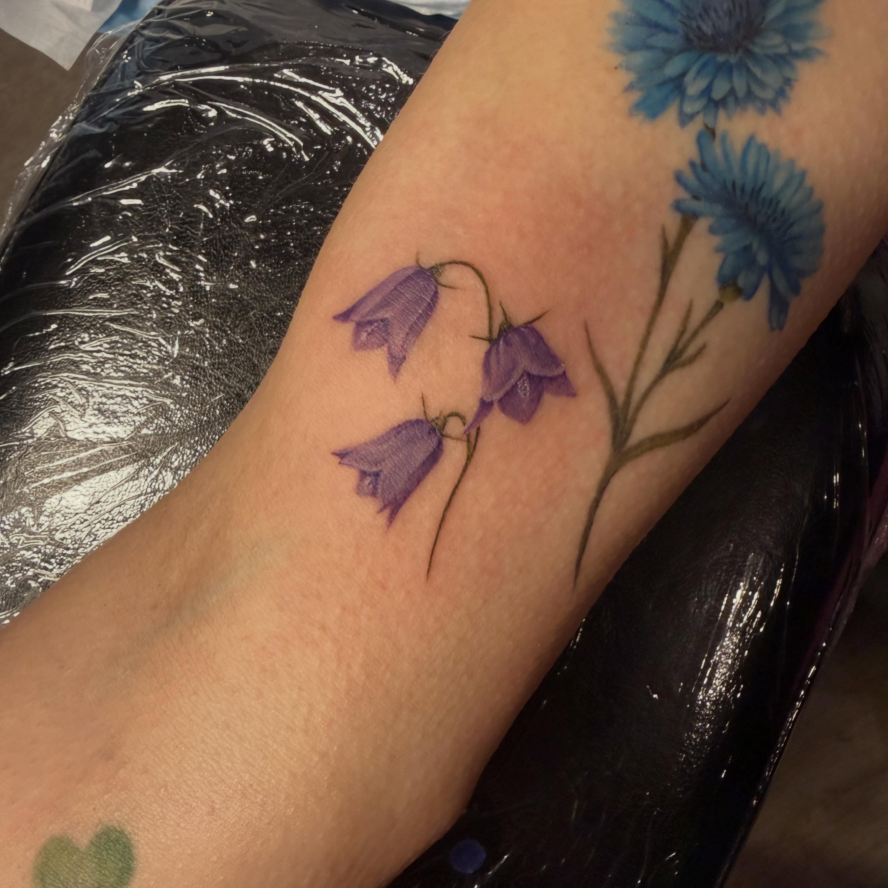 Bellflowers realism tattoo on the forearm by Shelly Elissa Tattoos