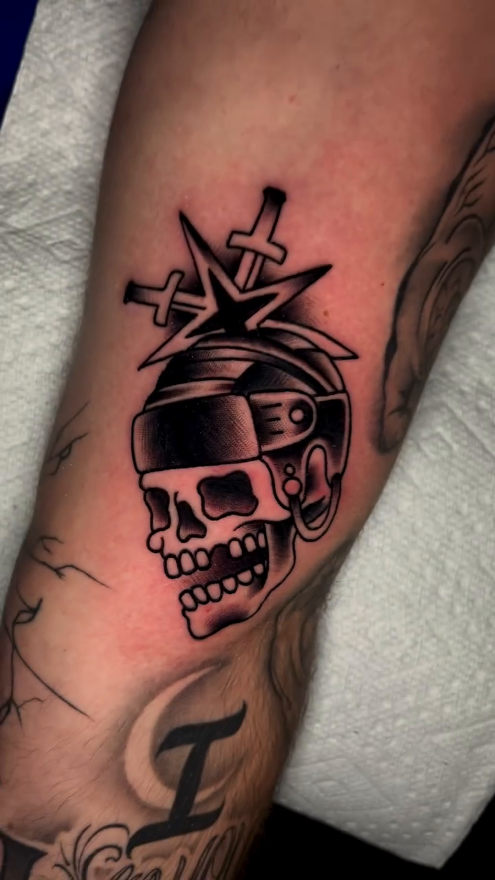 Skull with goggles and knives realism tattoo on the forearm by Nick Andrade Las Vegas Tattoo Artist