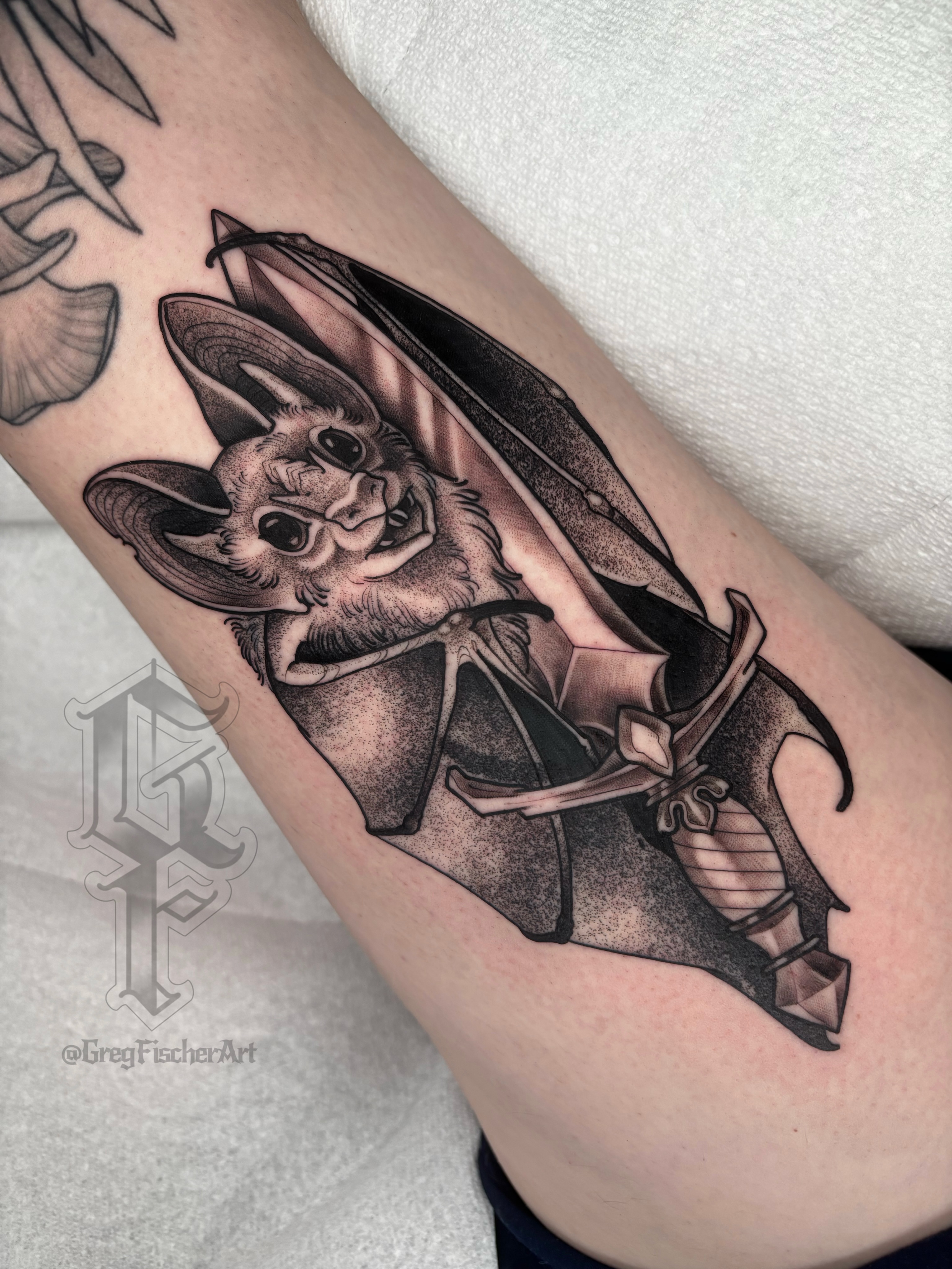 Bat black and grey tattoo on the forearm by Greg Fischer
