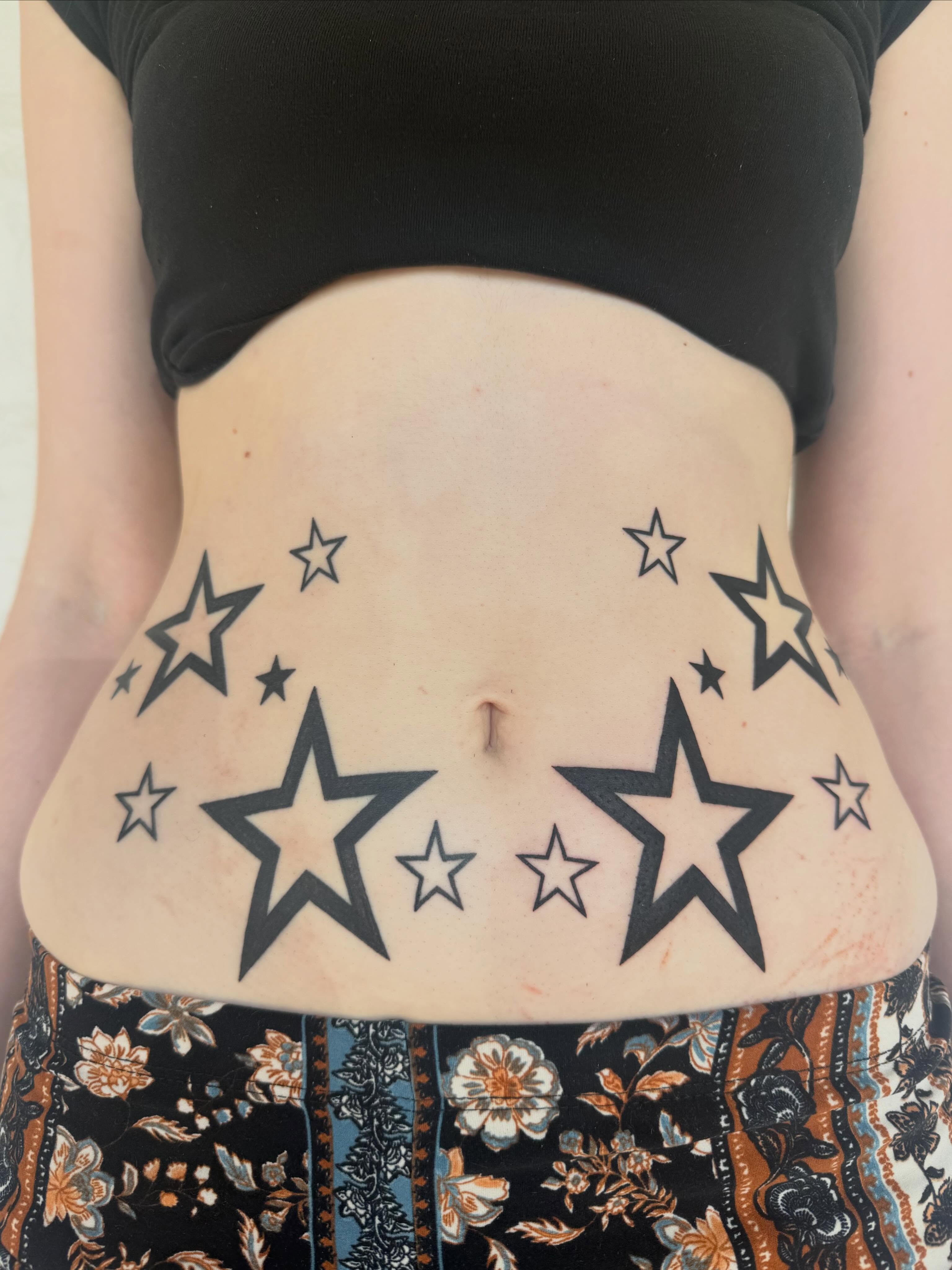 Stars black and grey tattoo on the torso by sarah