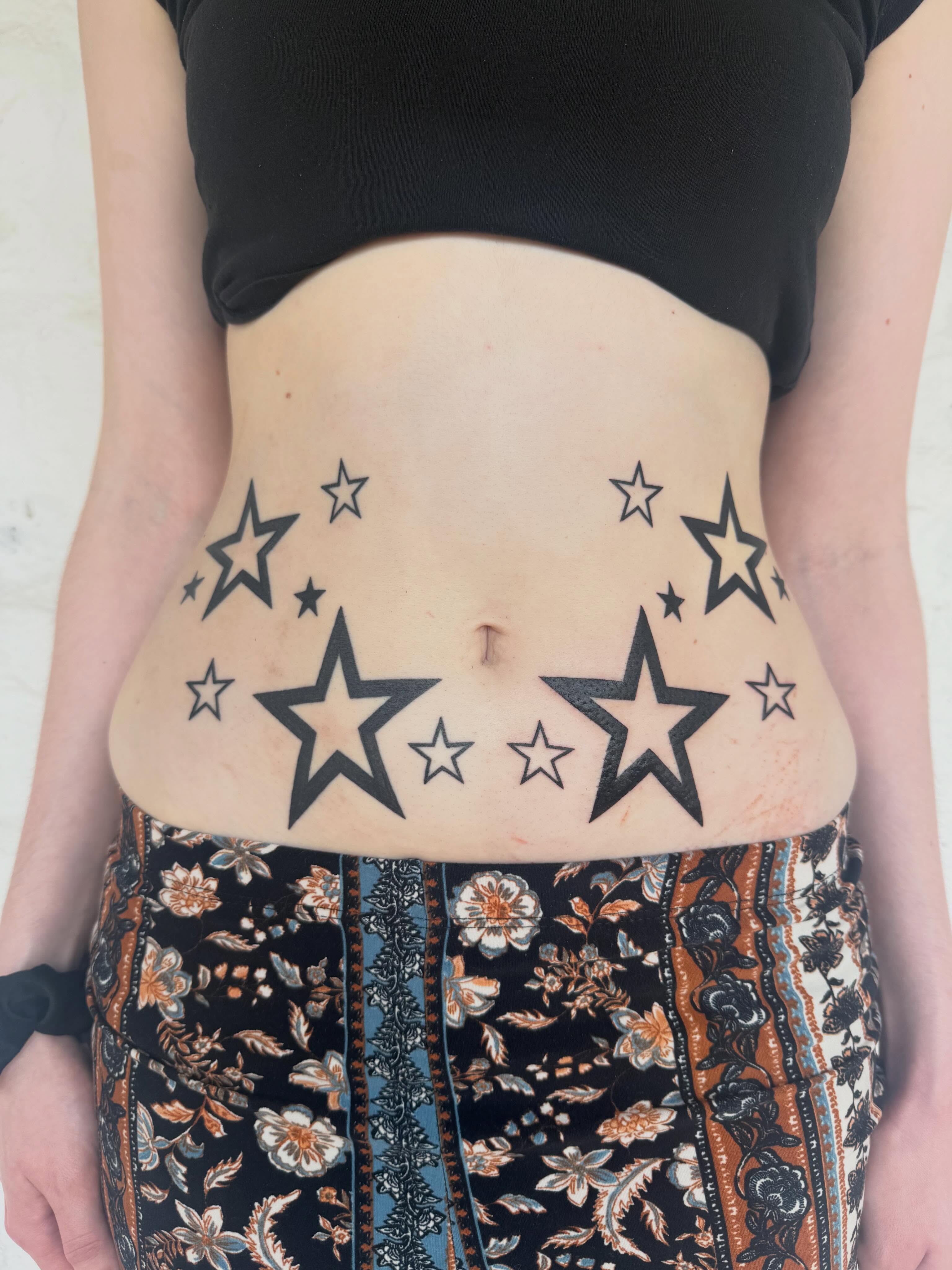 Stars black and grey tattoo on the torso by sarah