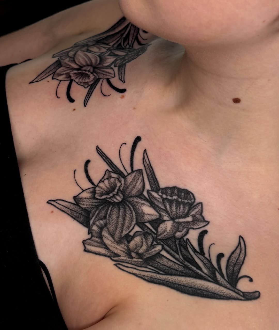 Daffodils dotwork tattoo on the chest by Kyle Kuhn