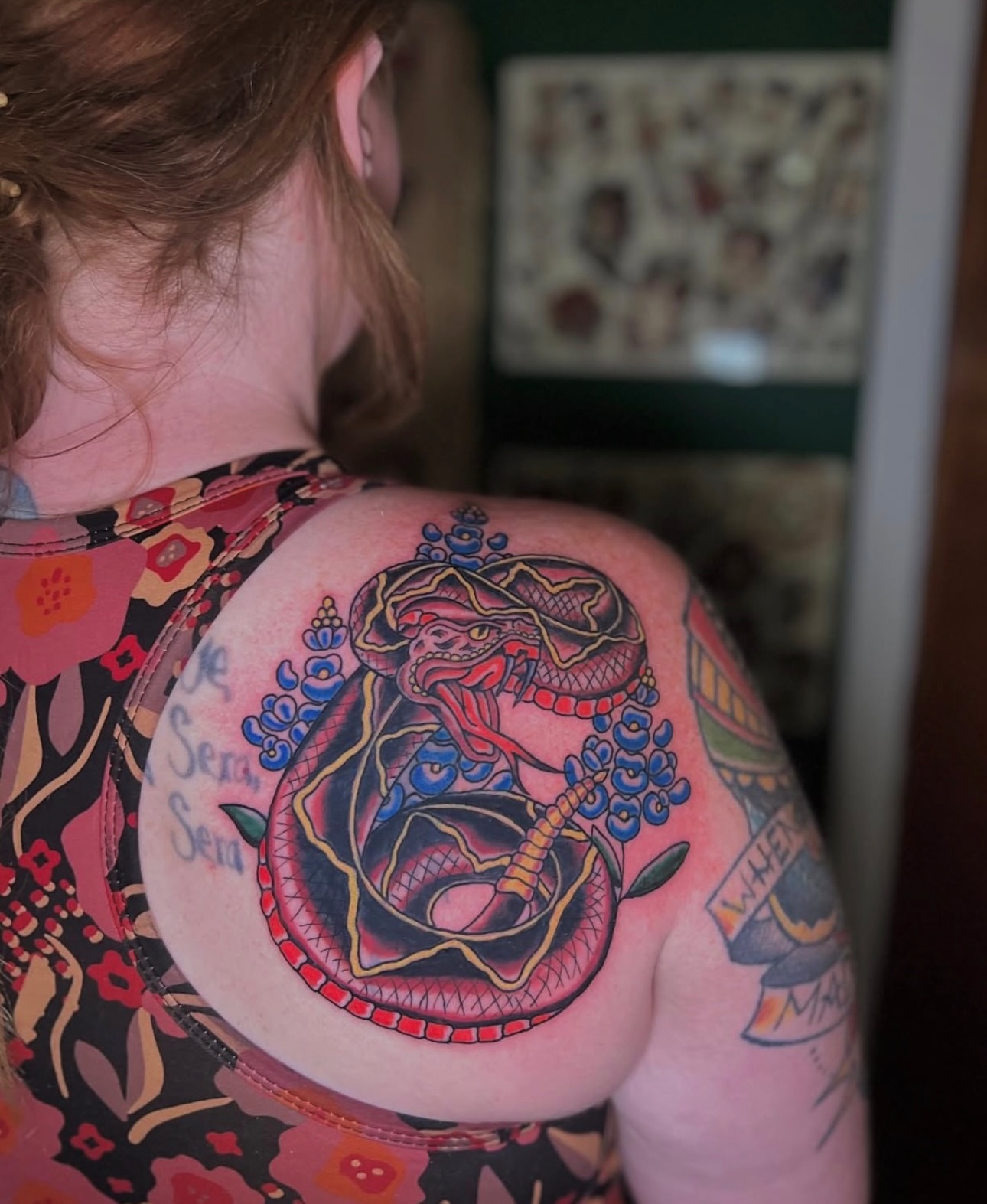 Snake and peony American traditional tattoo on the shoulder by Dustie Pitstick