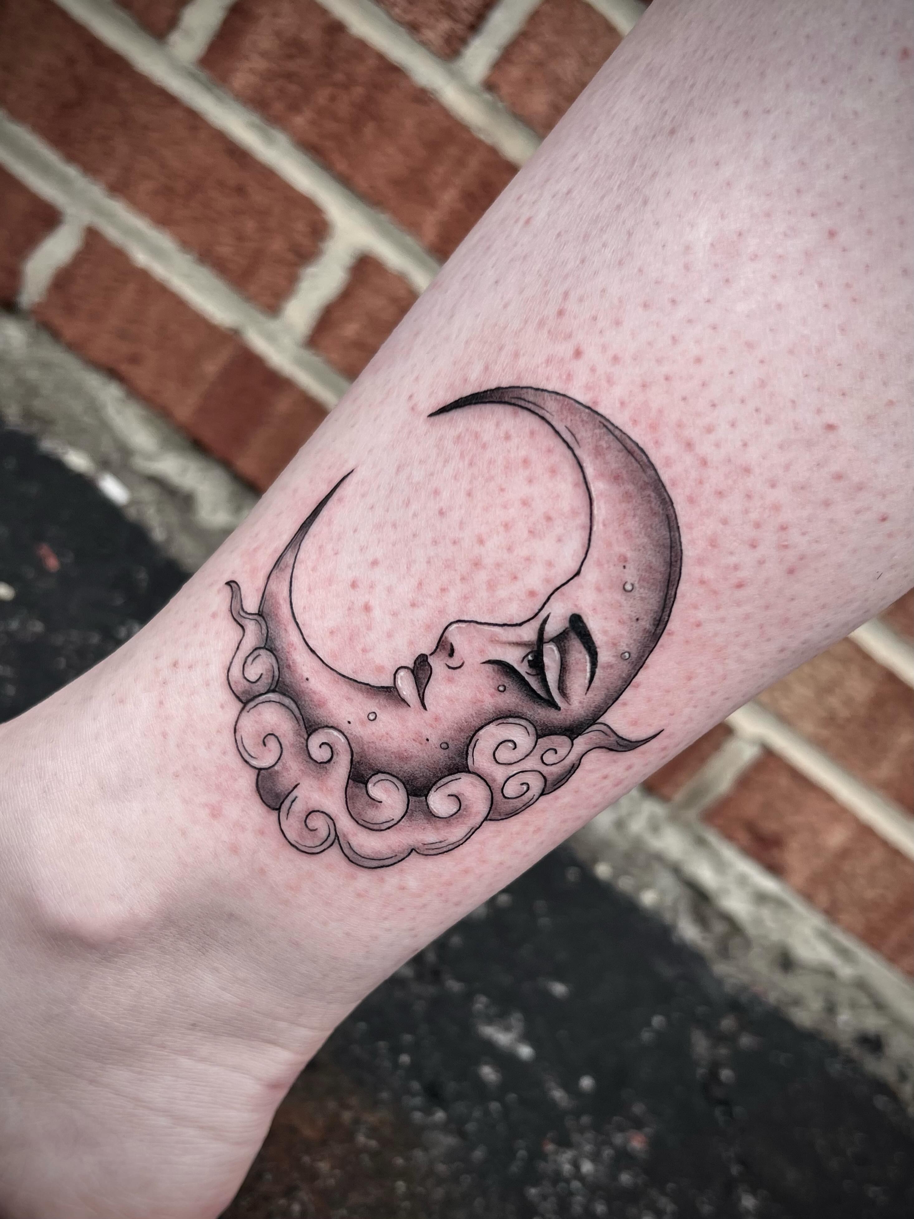 Moon and face black and grey tattoo on the forearm by Lexi Rose