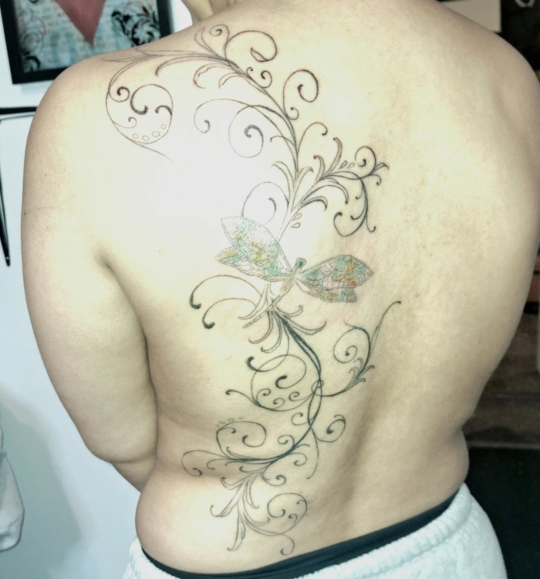Dragonfly and vine blackwork tattoo on the back by hallowed girl tattoo