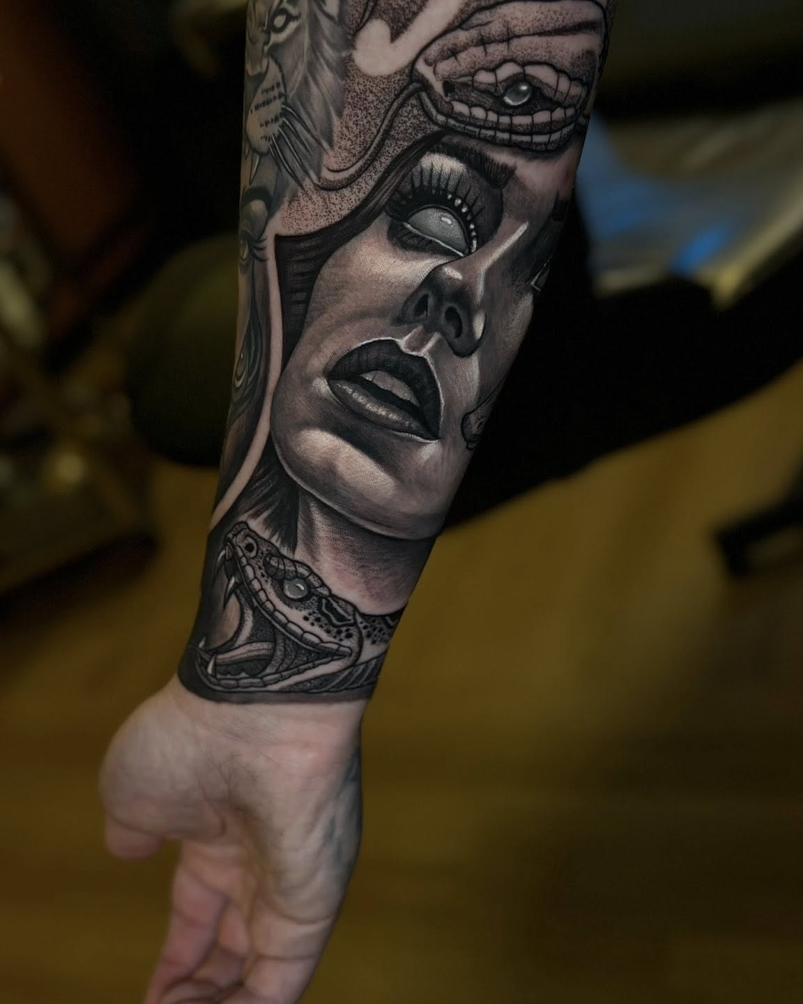 Skull and snake realism tattoo on the forearm by Joel Ortiz Ginorio