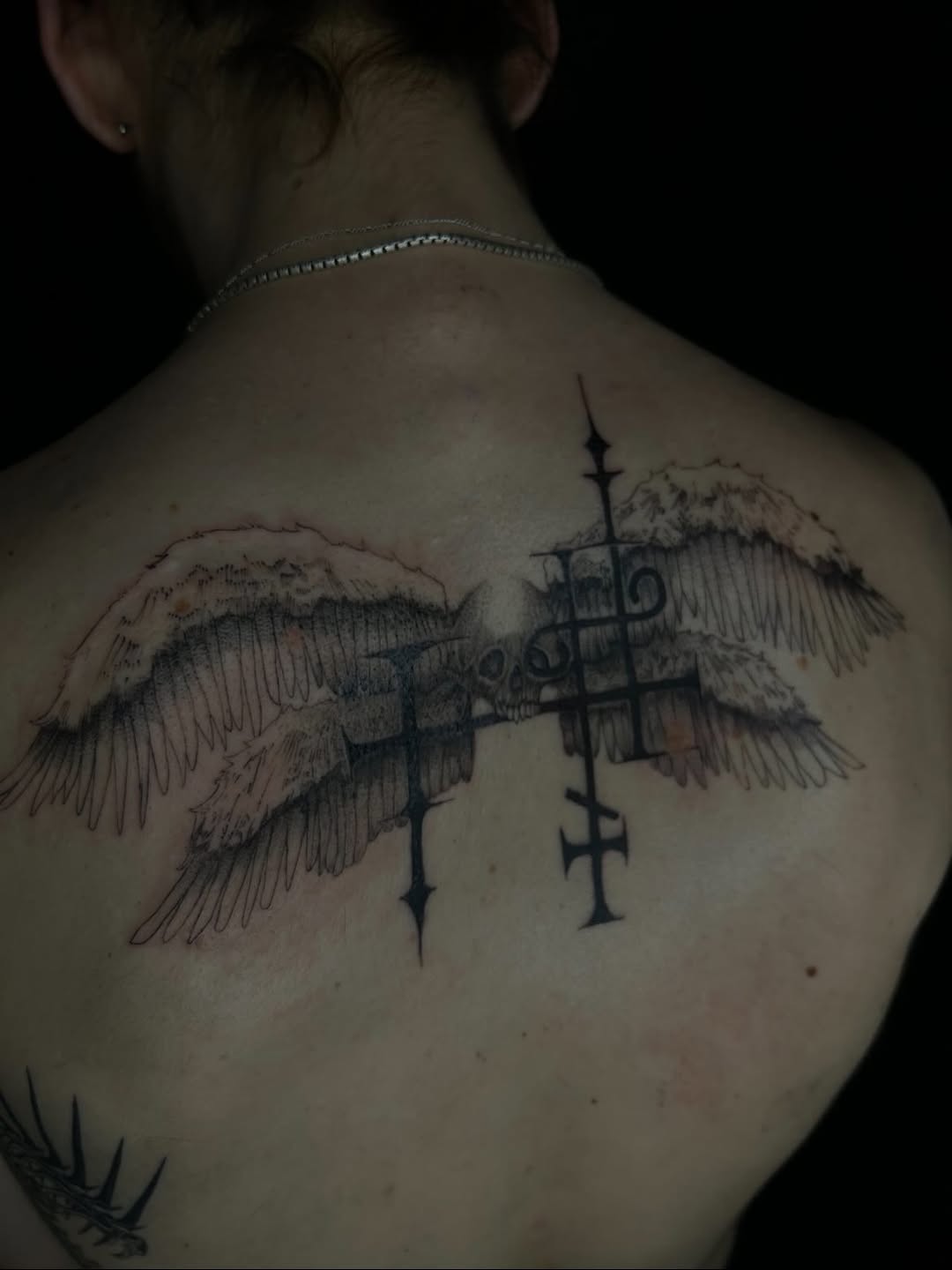 Winged skull with crosses cyber sigilism tattoo on the back by Jadin Nichols