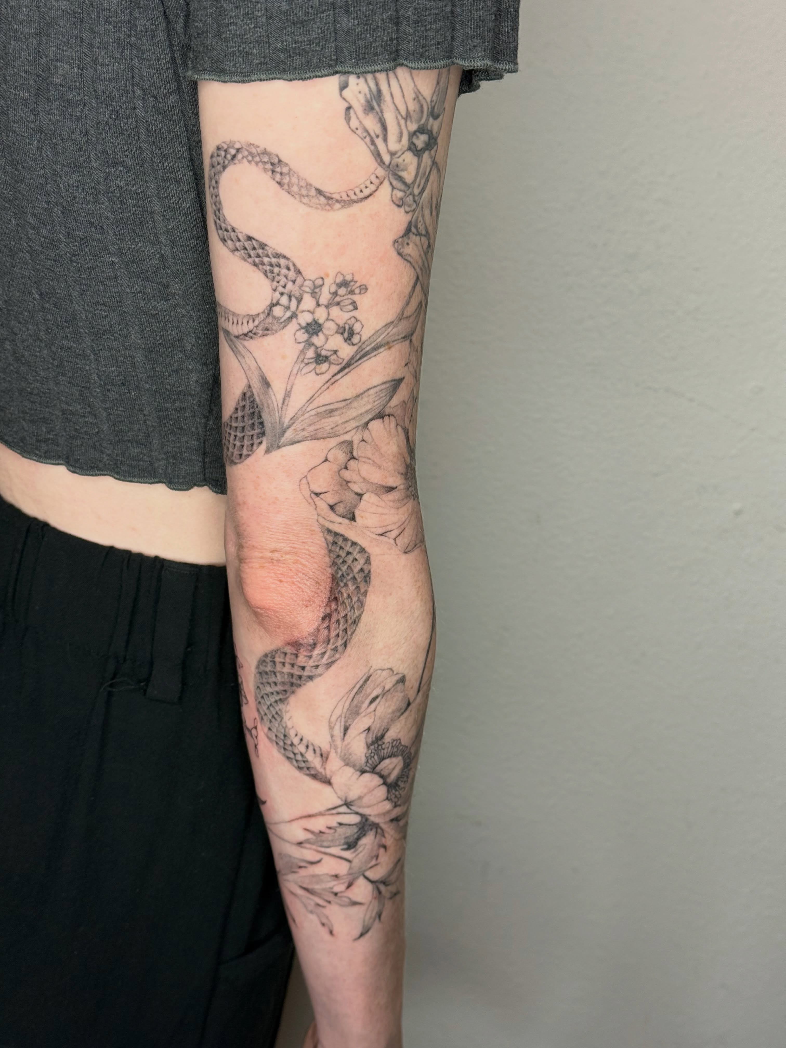 Snake and flowers realism tattoo on the forearm by ❁ Marlo Marquise Tattoo Artist ❁
