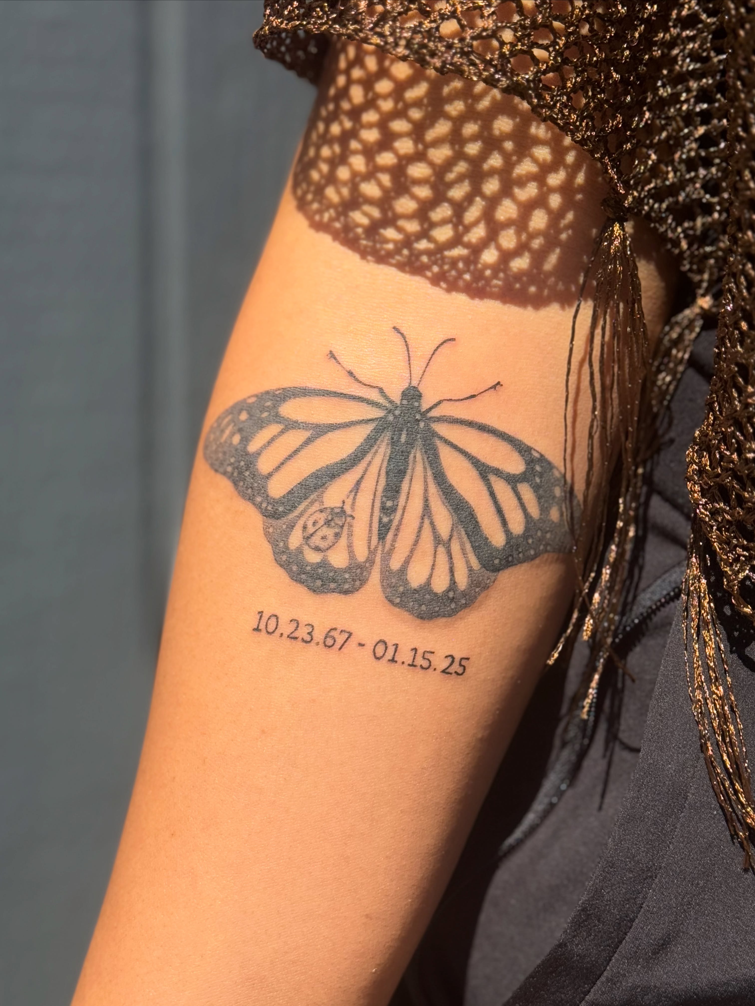 Monarch butterfly black and grey tattoo on the forearm by Leti
