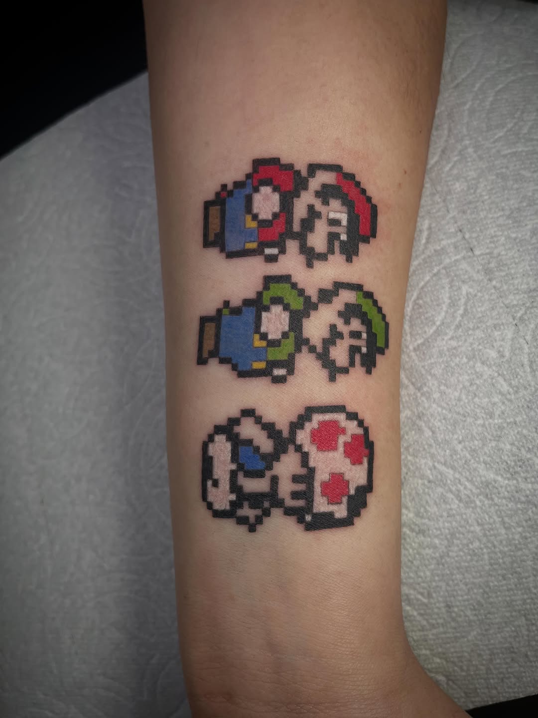 Mario and Luigi characters new school tattoo on the forearm by Peach ๐, Portland, Oregon