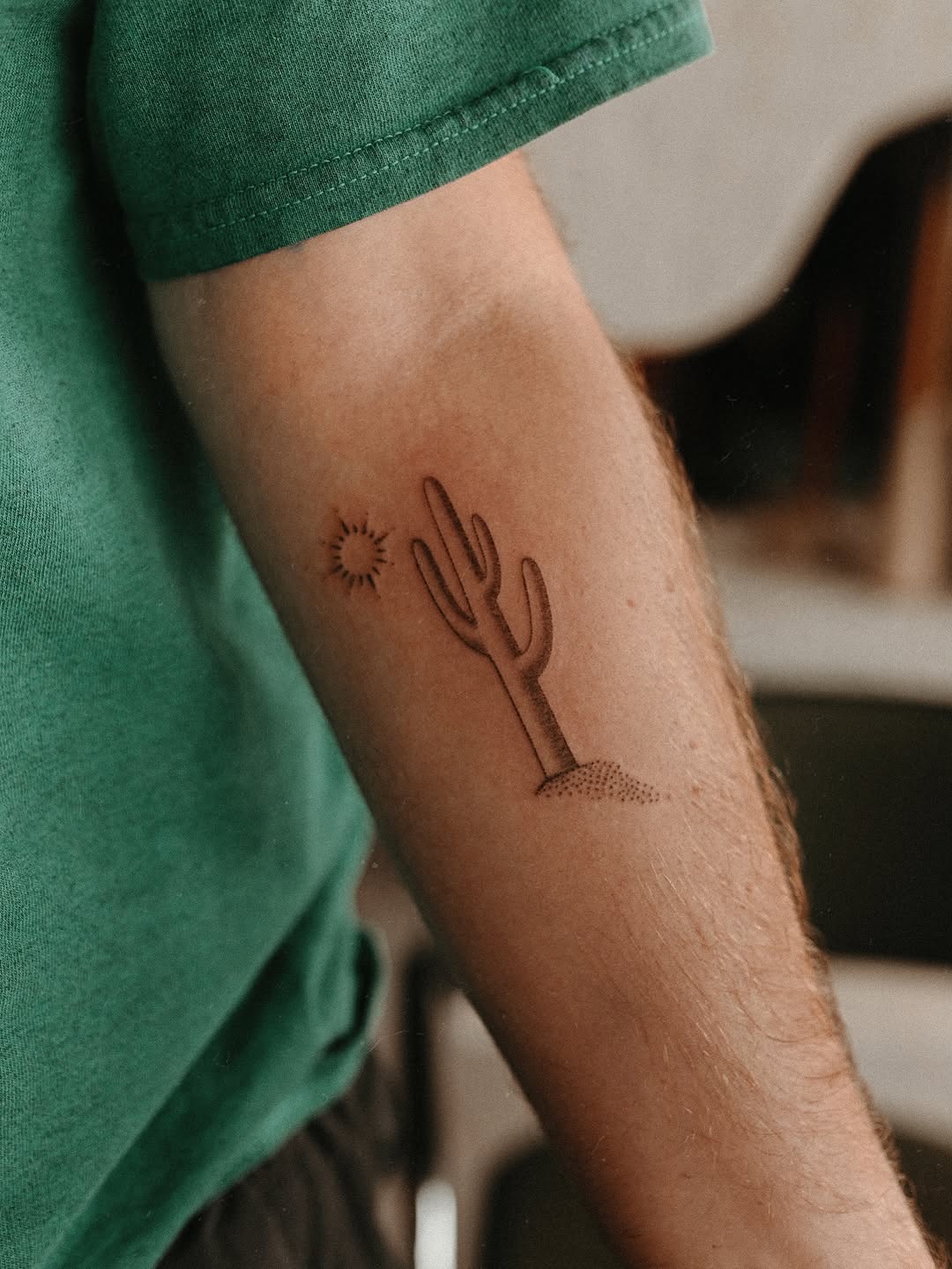 Cactus and sun fine line tattoo on the forearm by Grace Wise - Handpoke Tattoos