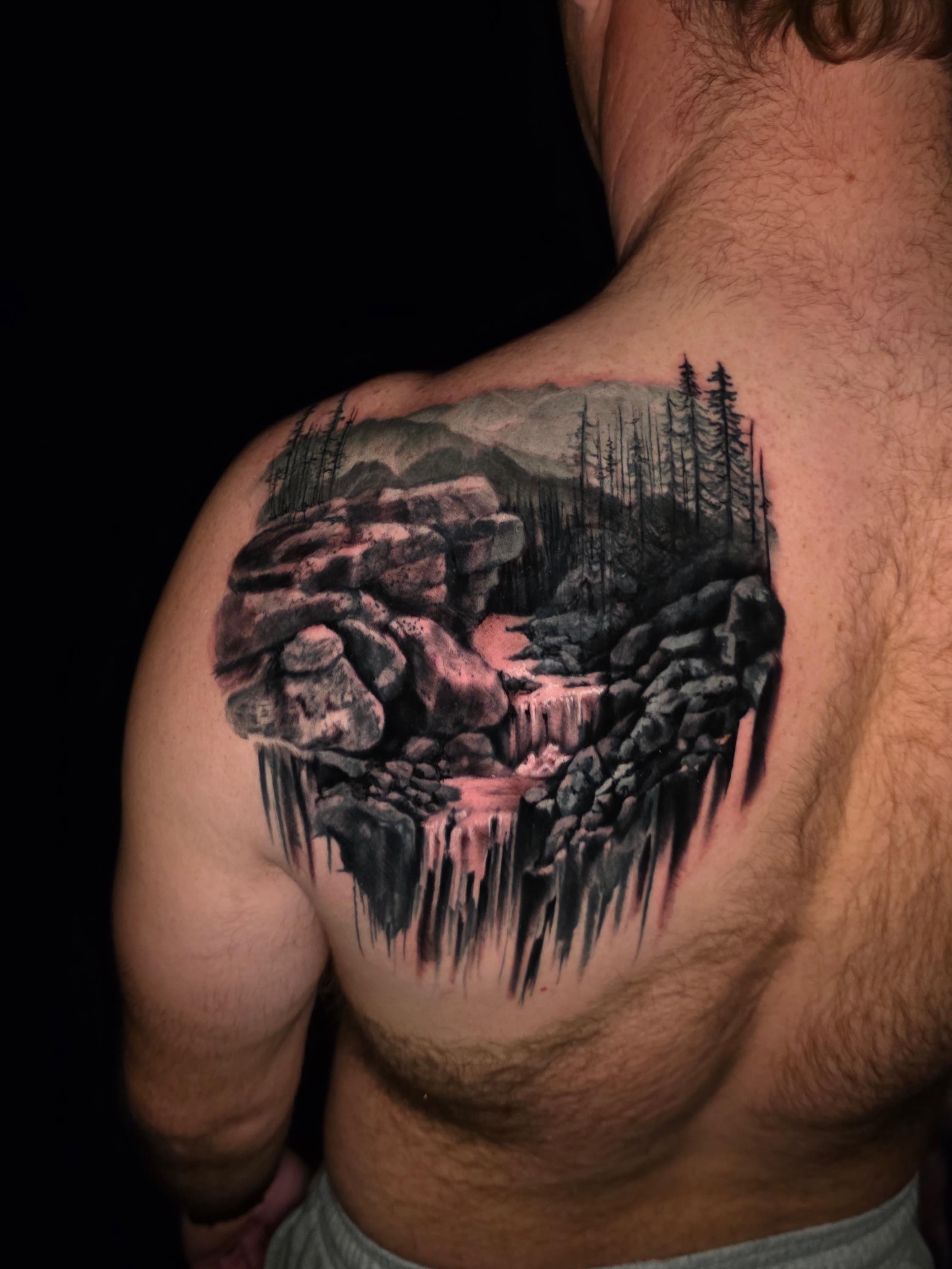 Mountain landscape realism tattoo on the shoulder by Tank Maass