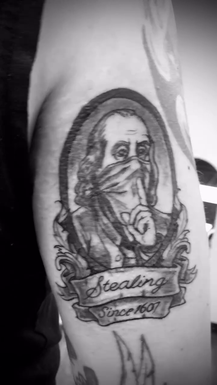 Benjamin Franklin portrait with bandana tattoo on the forearm by Dharm, Denver, Colorado