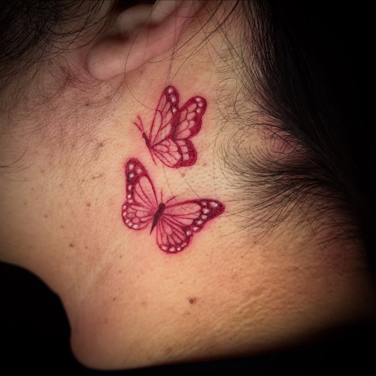 Butterflies dotwork tattoo on the neck by Monica Gonzalez