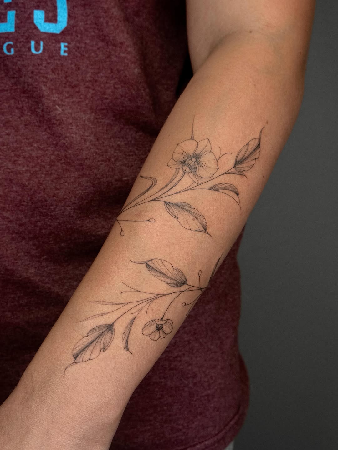 Floral vine with orchids and leaves fine line tattoo on the forearm by ๐๐๐ฆ ๐๐ ๐ฎ๐ฒ๐๐ง