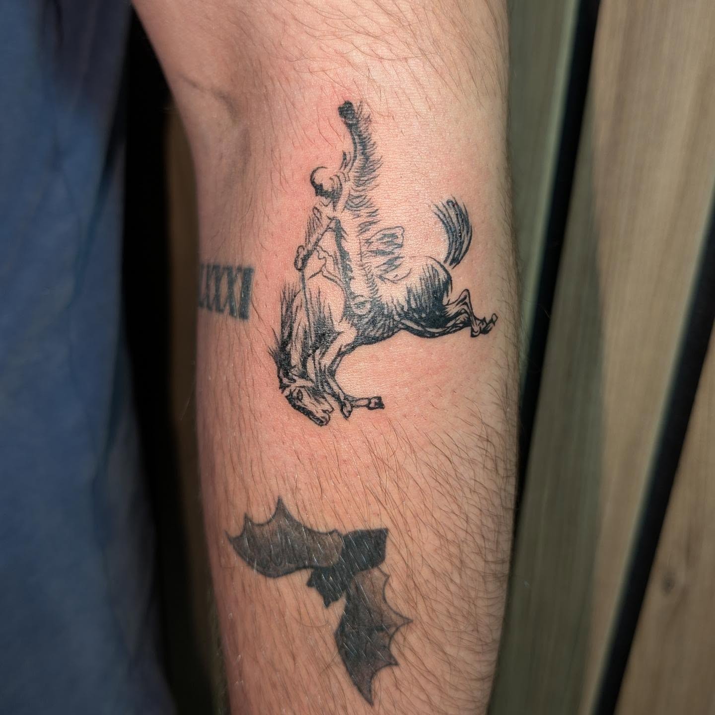 Horse and rider black and grey tattoo on the forearm by Tony