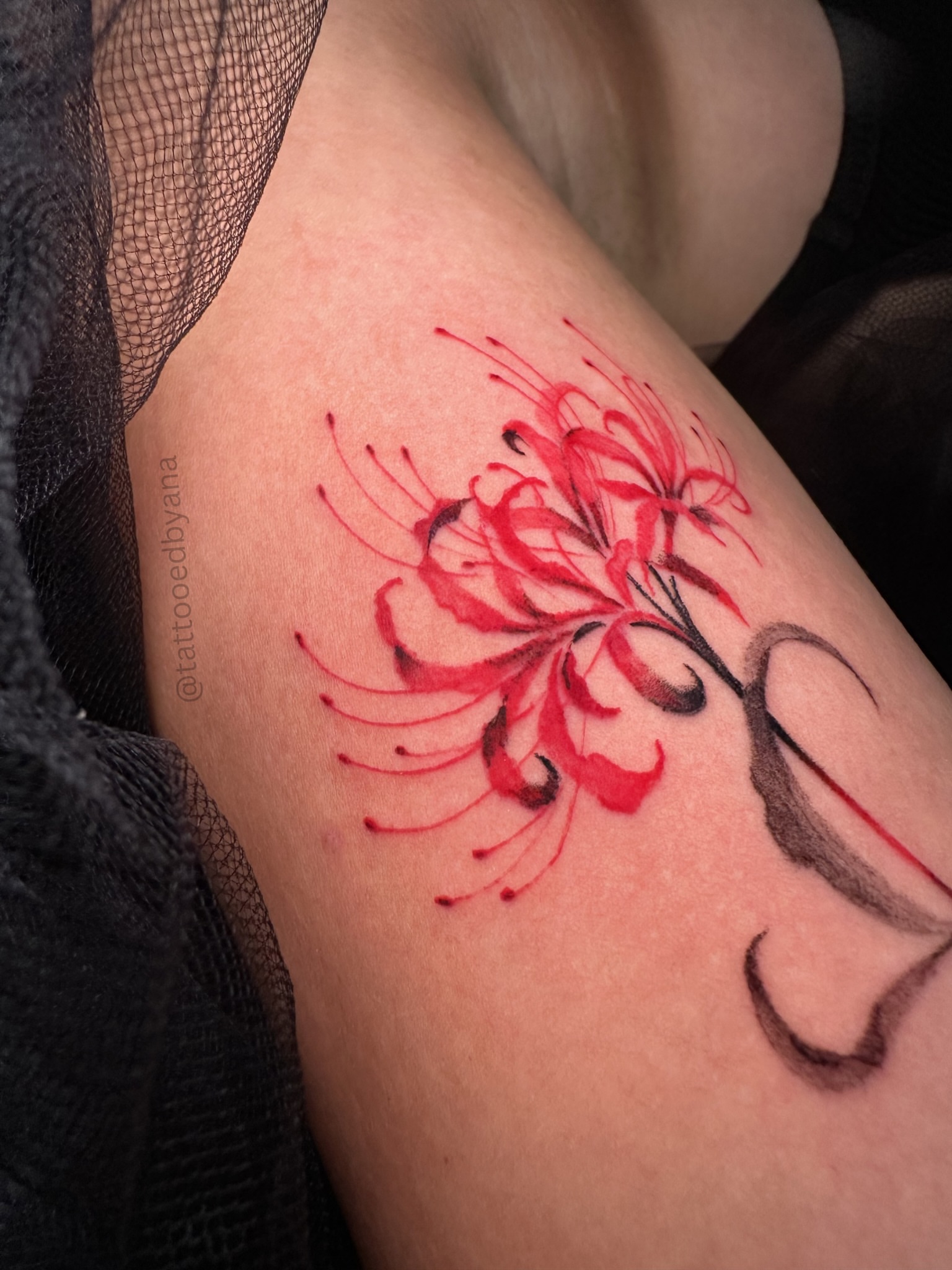 Red spider lily watercolor tattoo on the forearm by Tattoo artist Denver