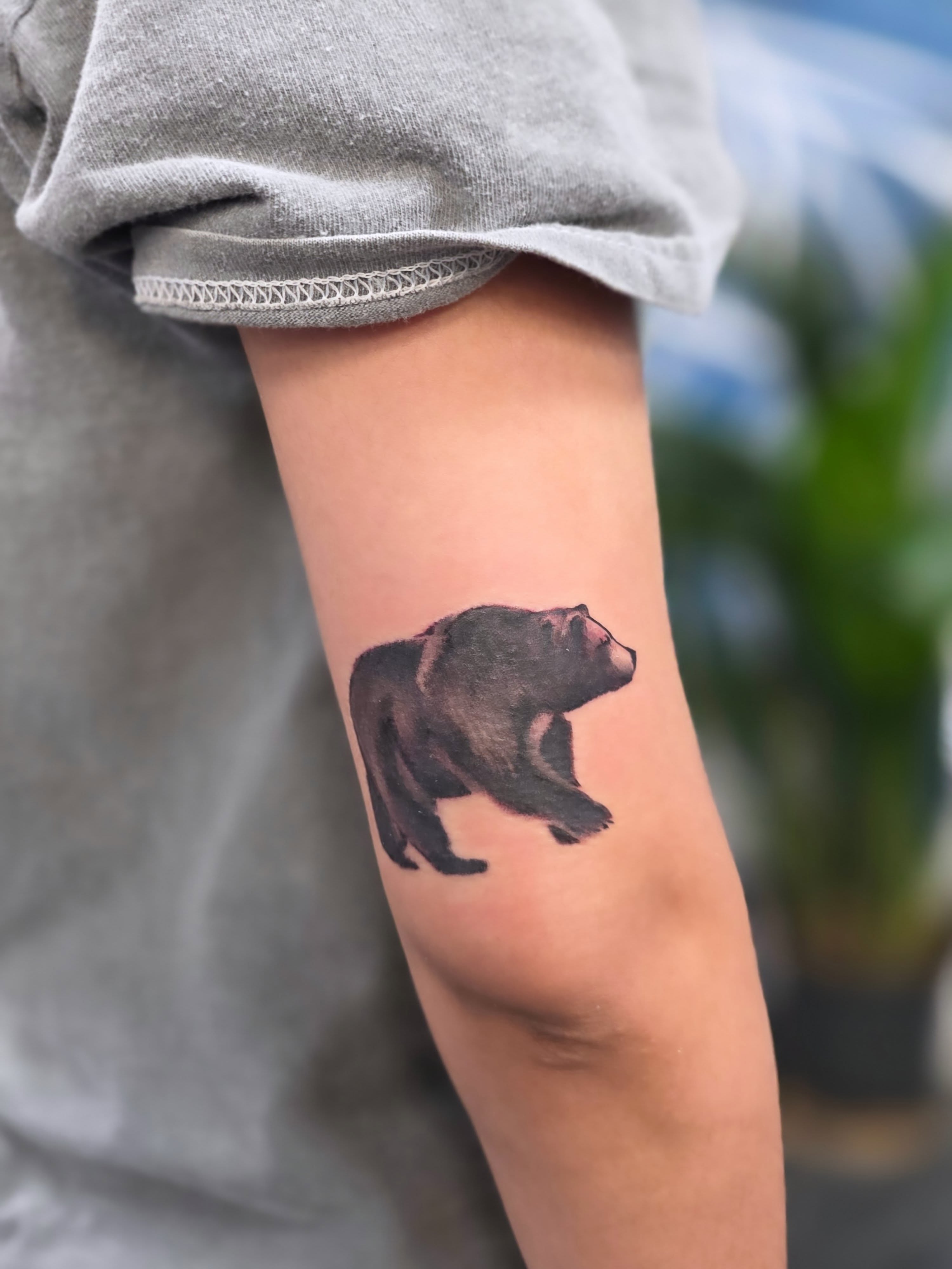 Bear black and grey tattoo on the forearm by Jo'el Acoba