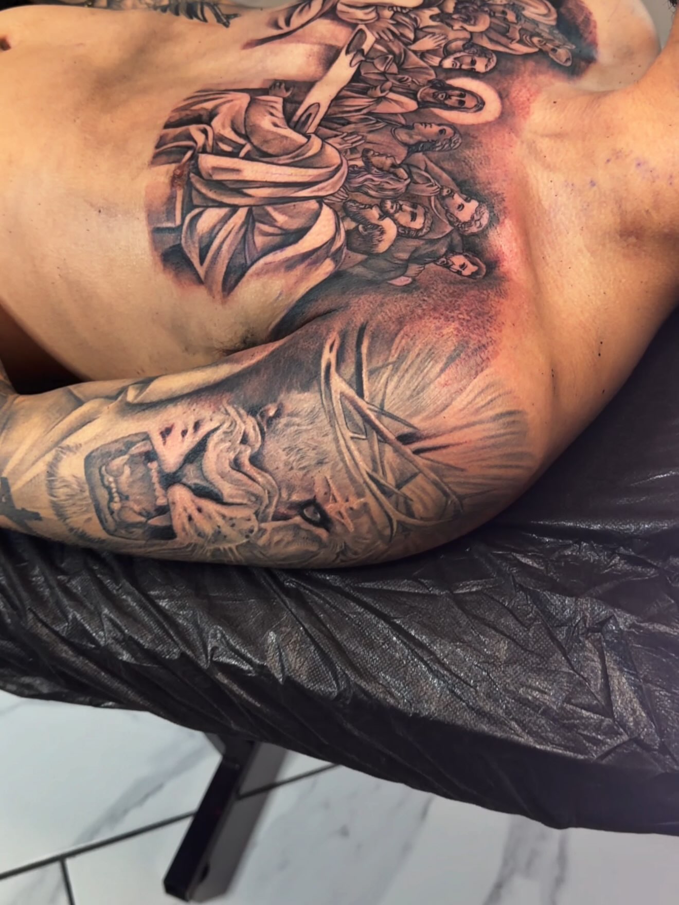 Religious scene black and grey tattoo on the back by Adrian gonzalez...