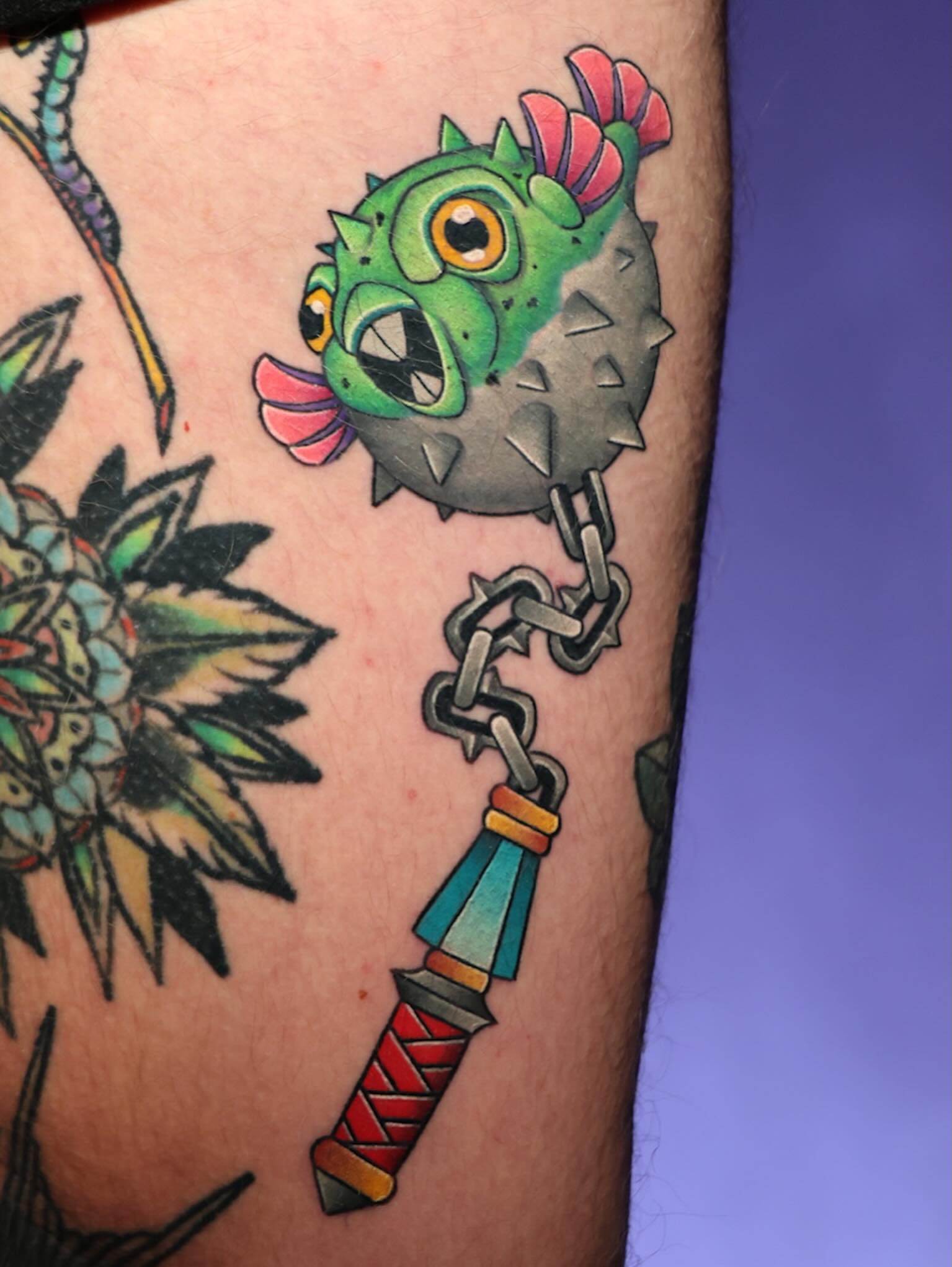 Puffer fish and sword American traditional tattoo on the forearm by Chi, Charlotte, North Carolina