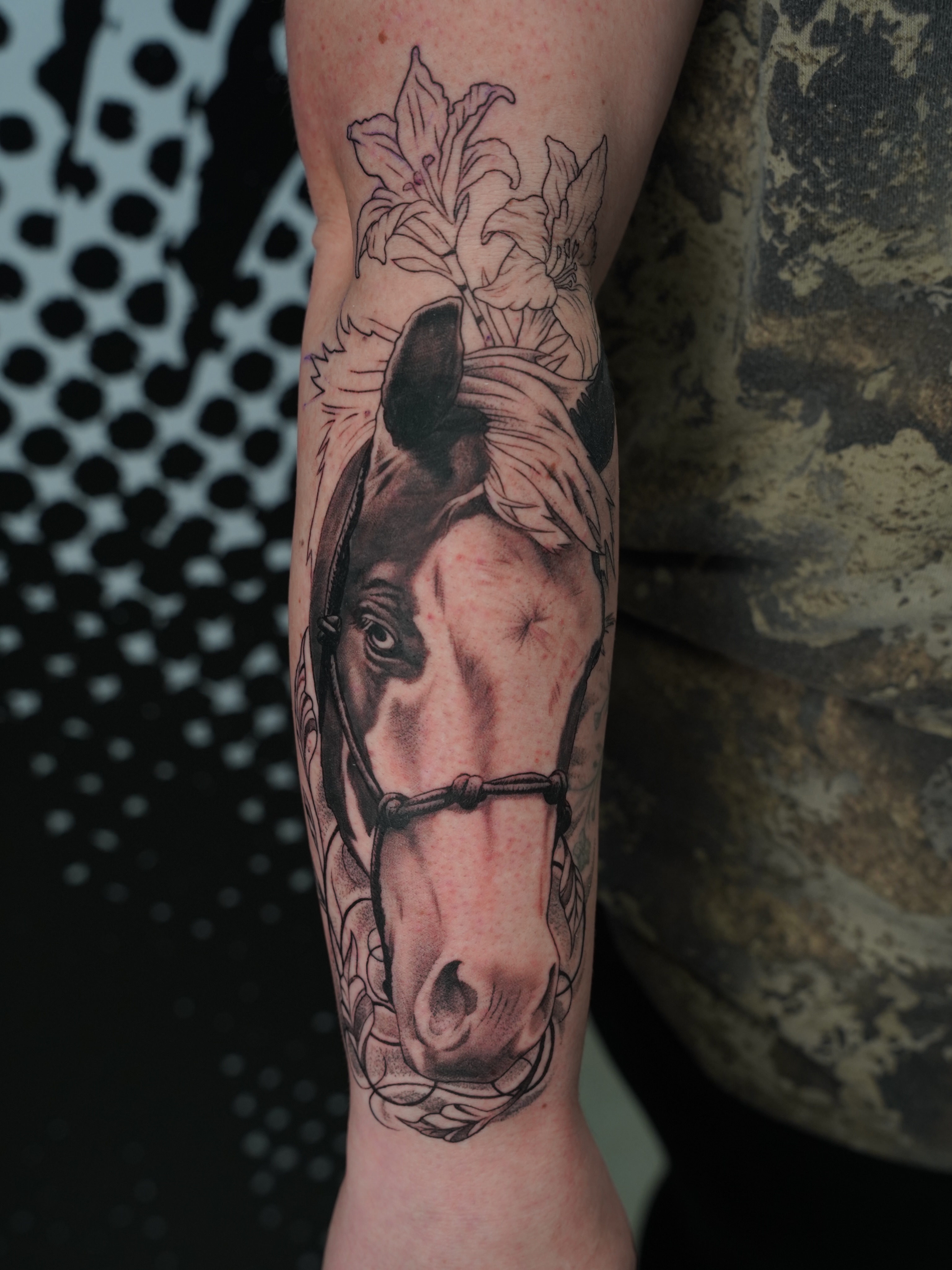 Horse head with lily realism tattoo on the forearm by Derek Foferek, Charlotte, North Carolina