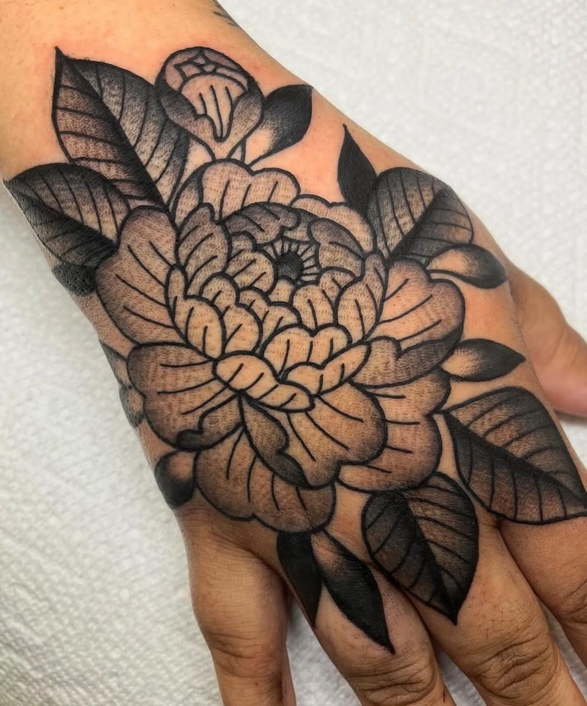 Chrysanthemum black and grey tattoo on the hand by ⭐️ Erin Bauer ⭐️