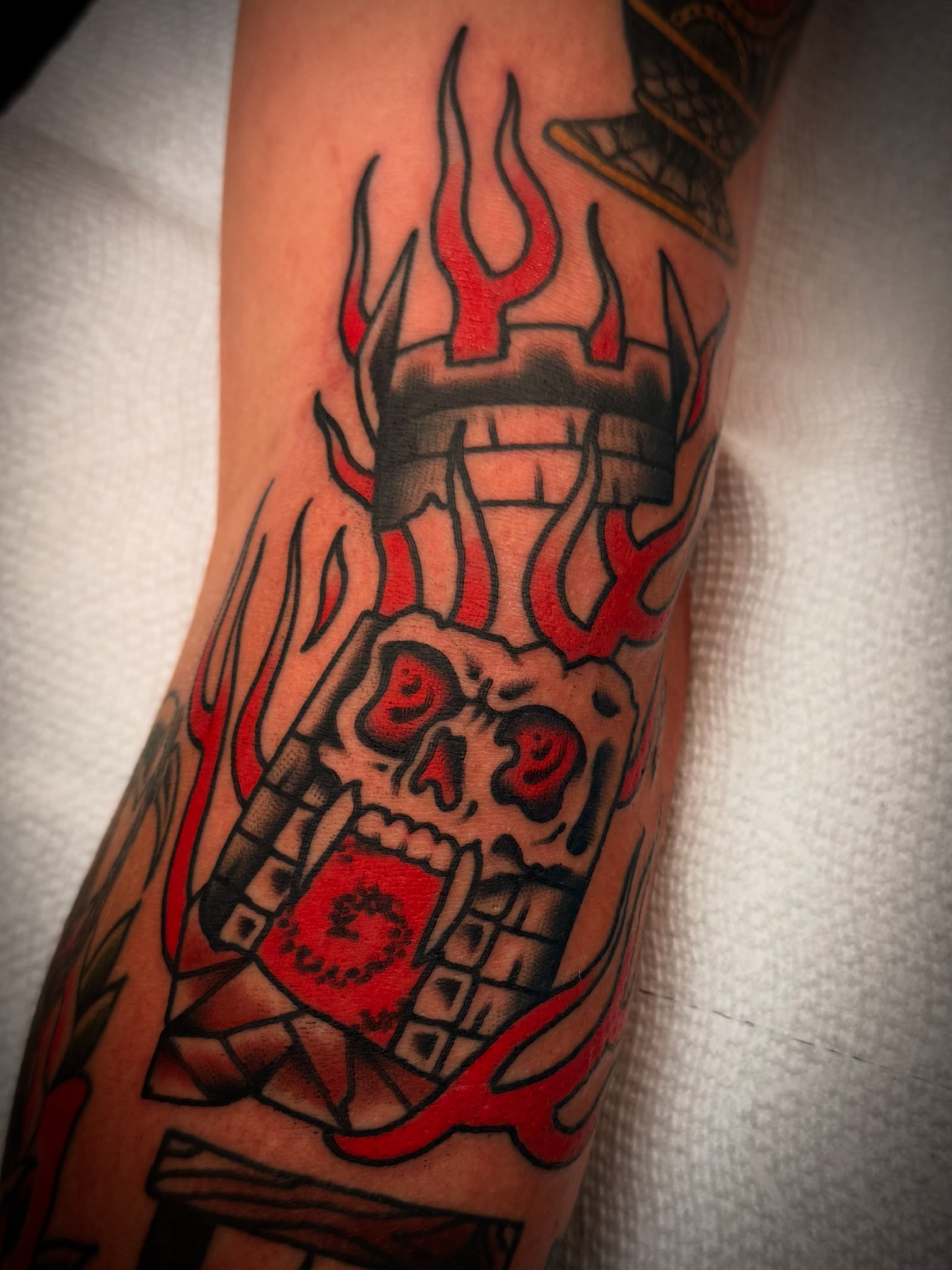 Flaming skull American traditional tattoo on the forearm by Dave Osrowitz