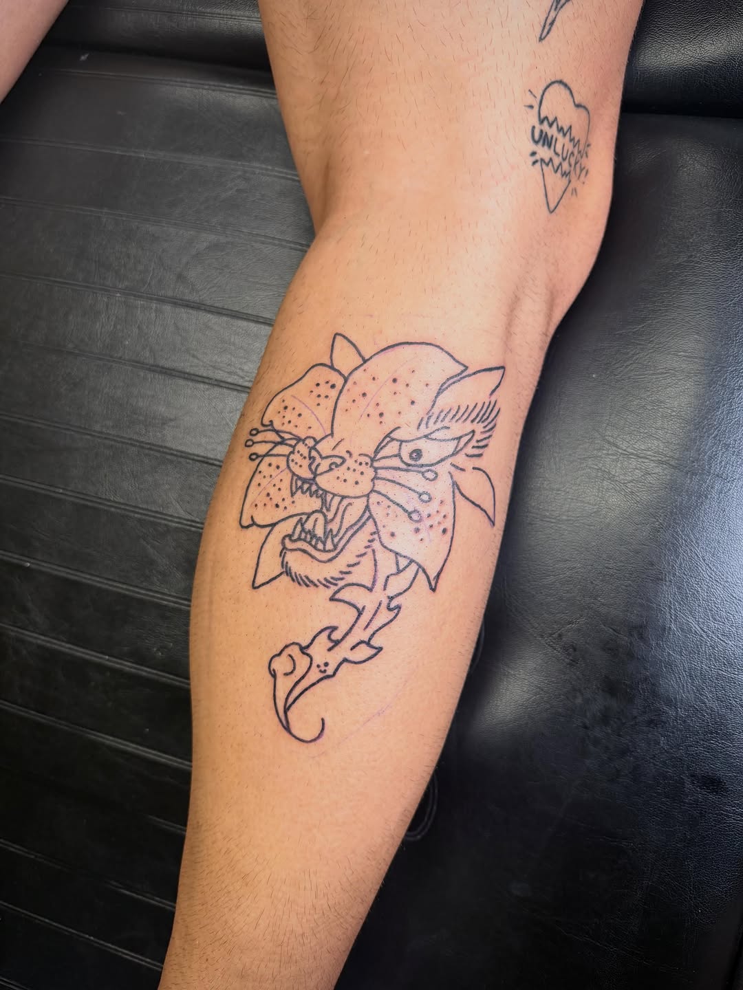 Panther head with flower realism tattoo on the forearm by ♱ C ♱, Dallas, Texas